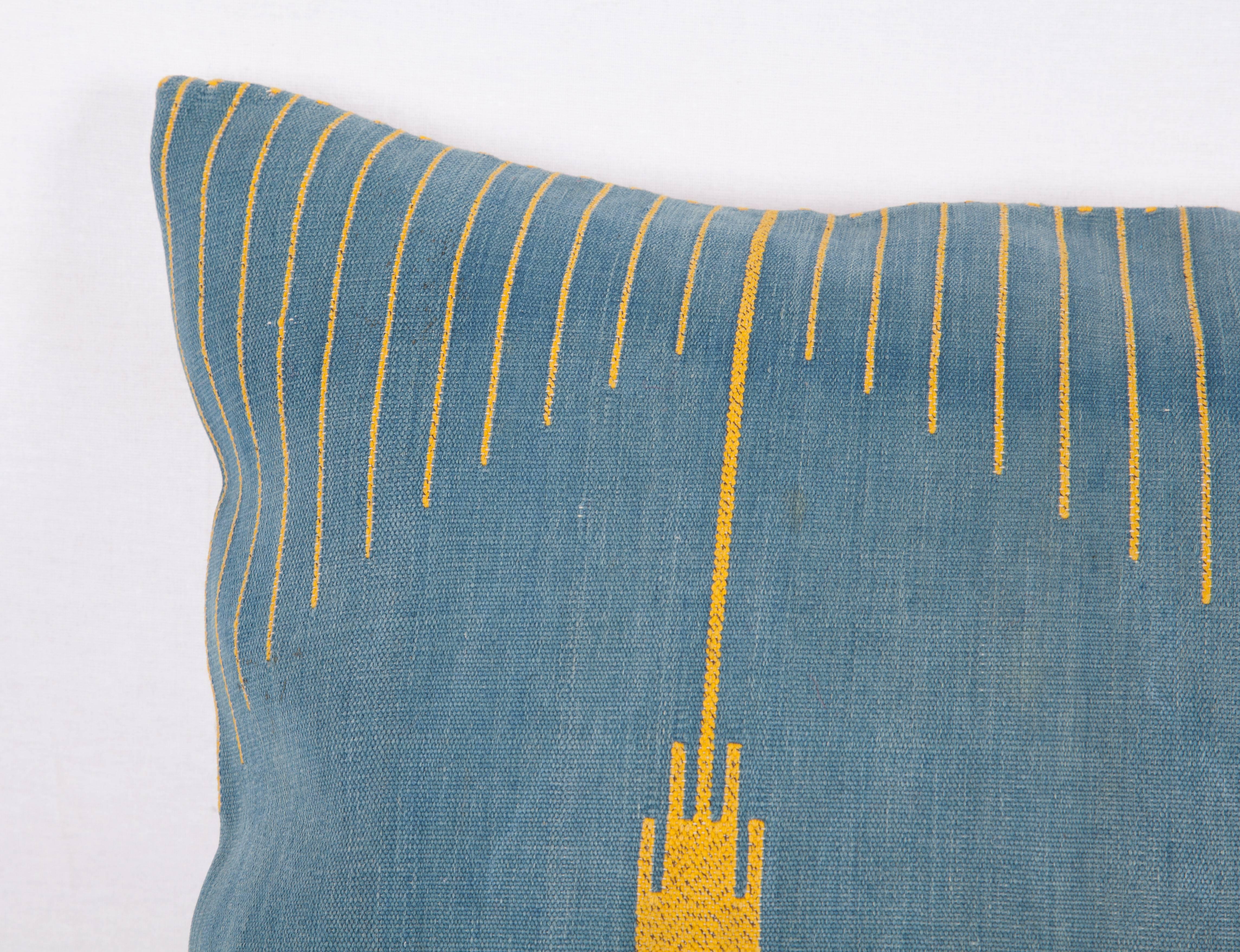 The textile that this pillow is made out of is probably a Syrian Bedouin weaving in cotton and metal thread.