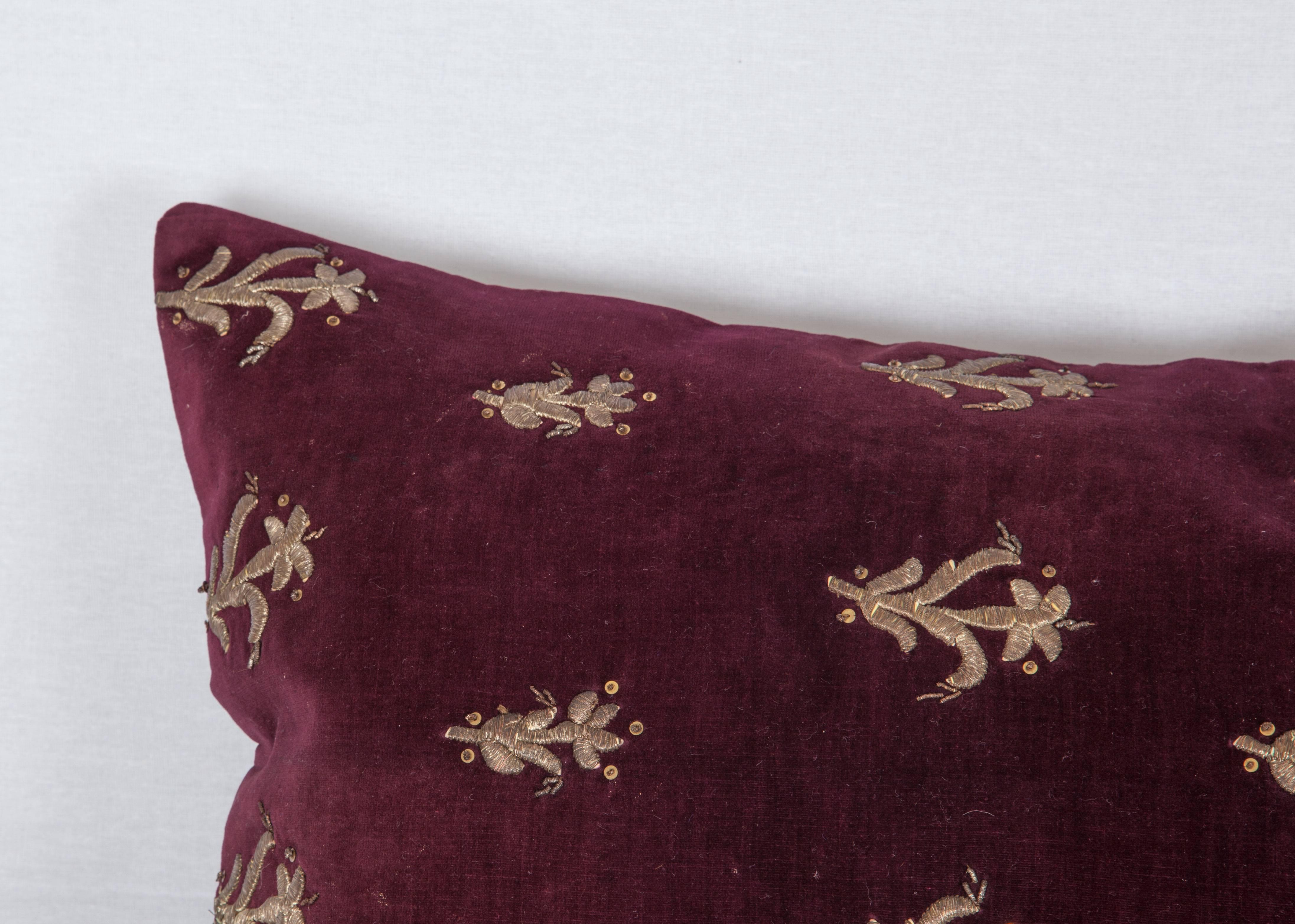 The pillow is made out of an early 19th century ottoman velvet embroidered in silver thread. It does not come with an insert but it comes with a bag made to the size and out of cotton to accommodate the filling. The backing is made of linen. Please