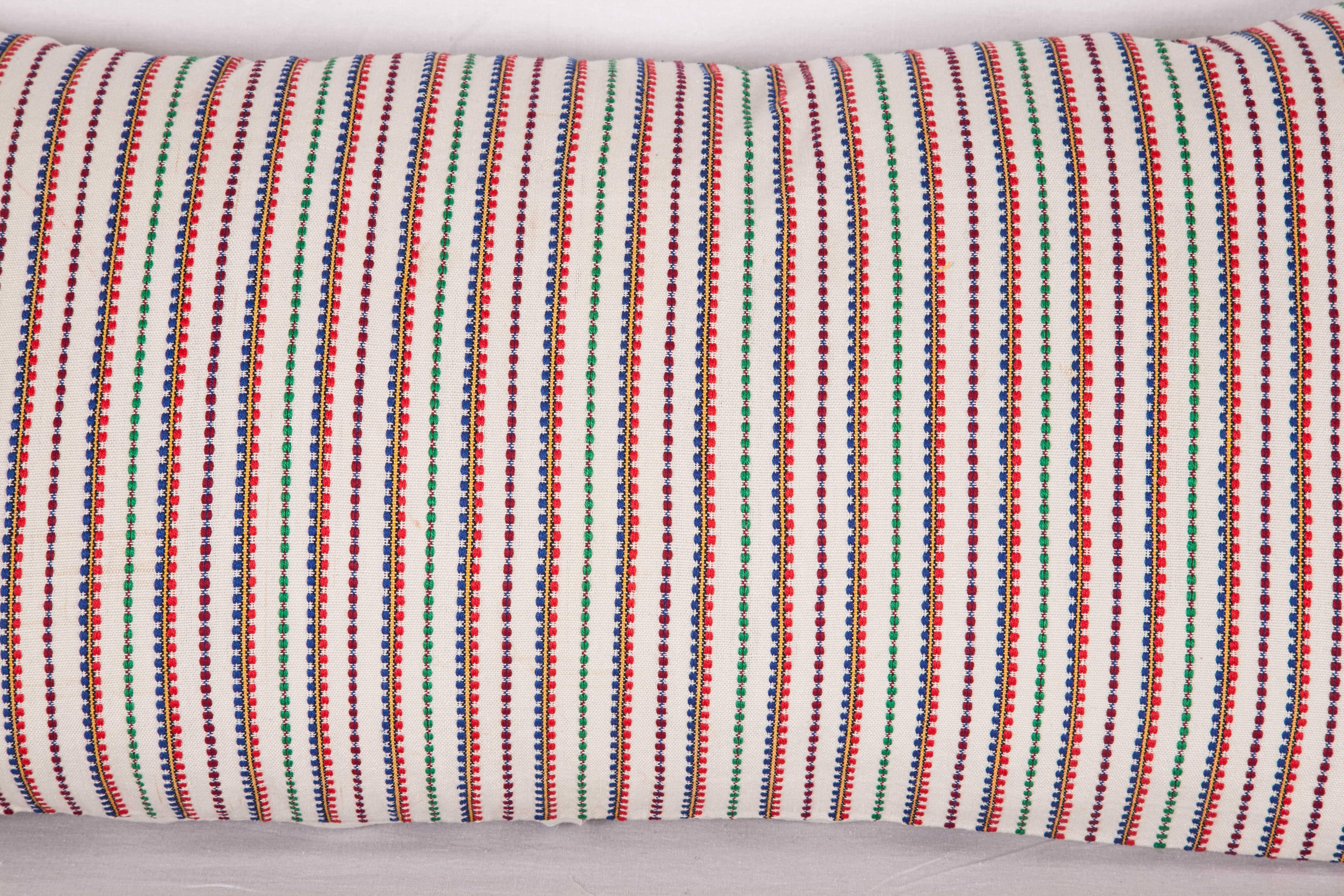The pillow is made out of a mid-20 century, Balkan (Bulgarian?) textile.
It does not come with an insert but it comes with a bag made to the size and out of cotton to accommodate the filling.
The backing is made of linen.
Please note filling is