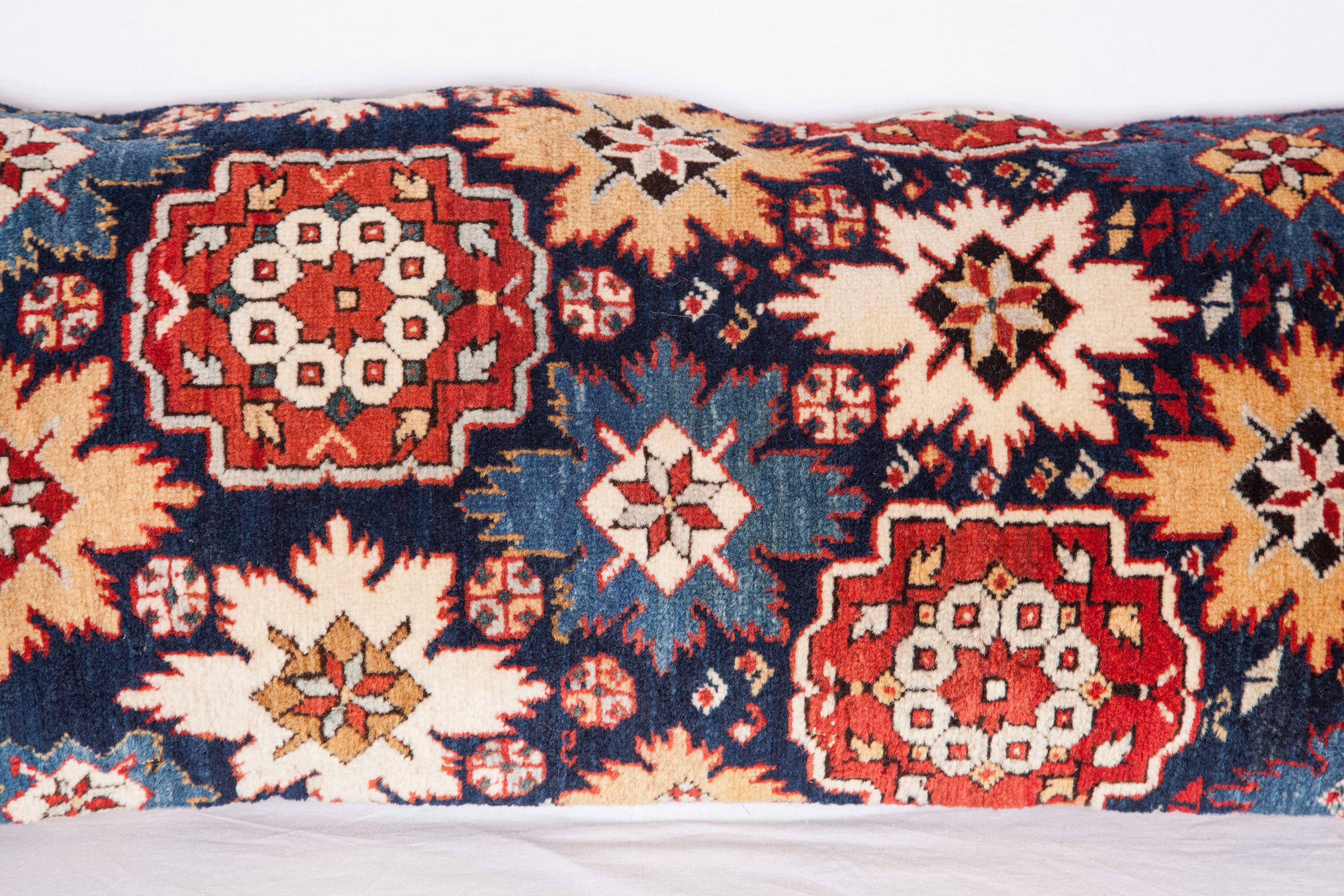 Pillow is made out of a 19th century fragment of a Caucasian Shriven rug. The pillow does not come with an insert but with a cotton bag made to the size to accommodate the insert material. The backing is made of linen. Please note filling is not