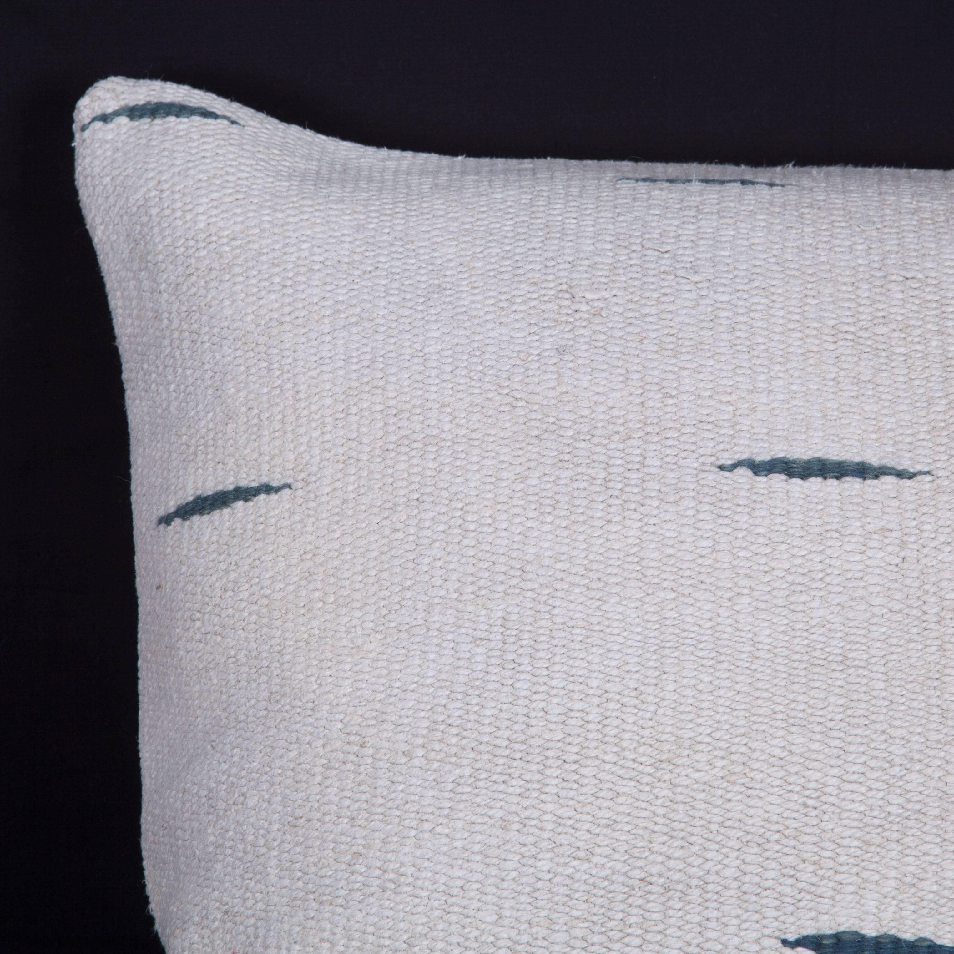 The pillow is made out of mid-20th century, Anatolian Hemp Kilim. It does not come with an insert but it comes with a bag made to the size and out of cotton to accommodate the filling. The backing is made of cotton. Please note 'filling is not