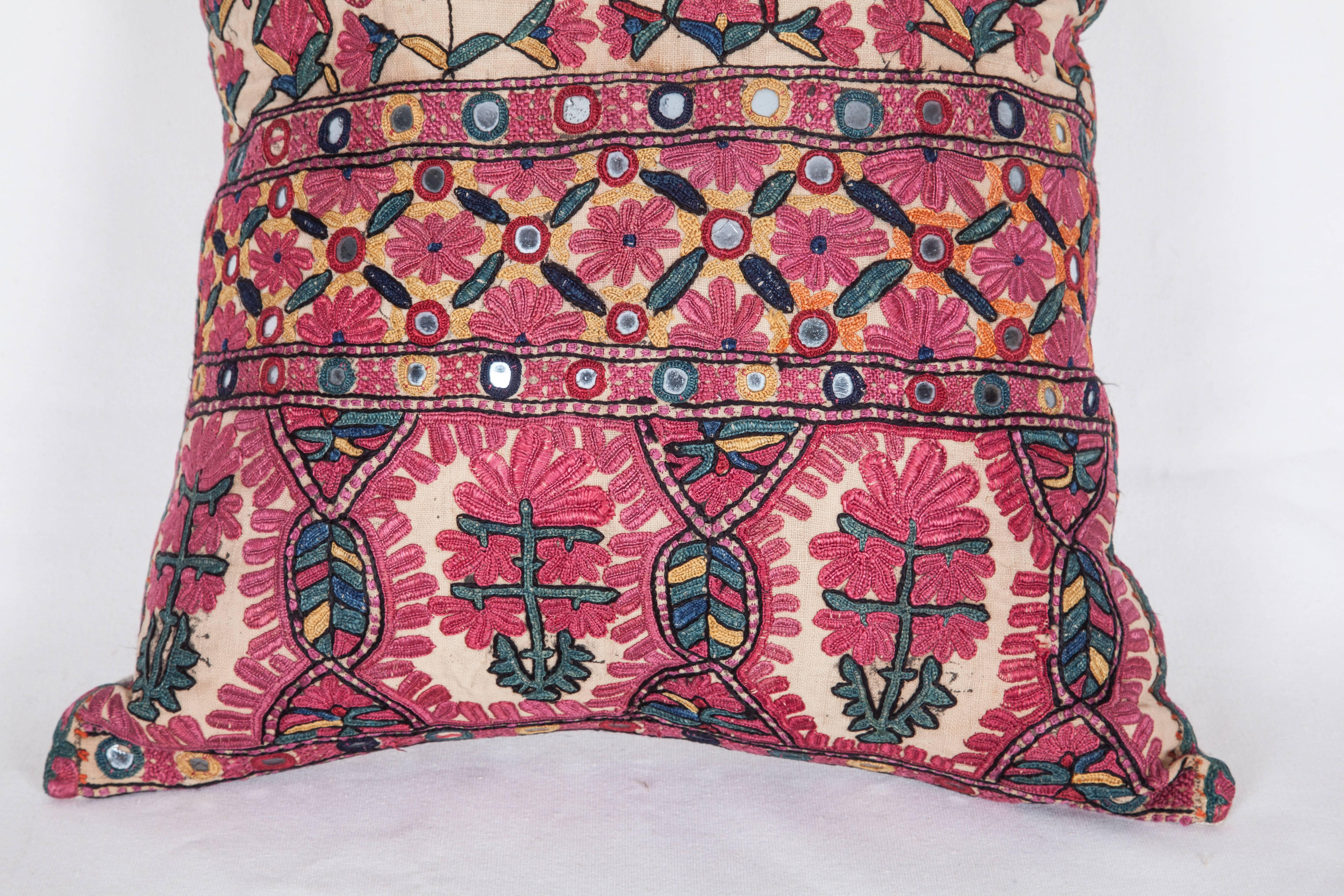 The pillow is made out of a late 19th century. Sind silk embroidery. It does not come with an insert but it comes with a bag made to the size and out of cotton to accommodate the filling. The backing is made of linen. Please note ' filling is not