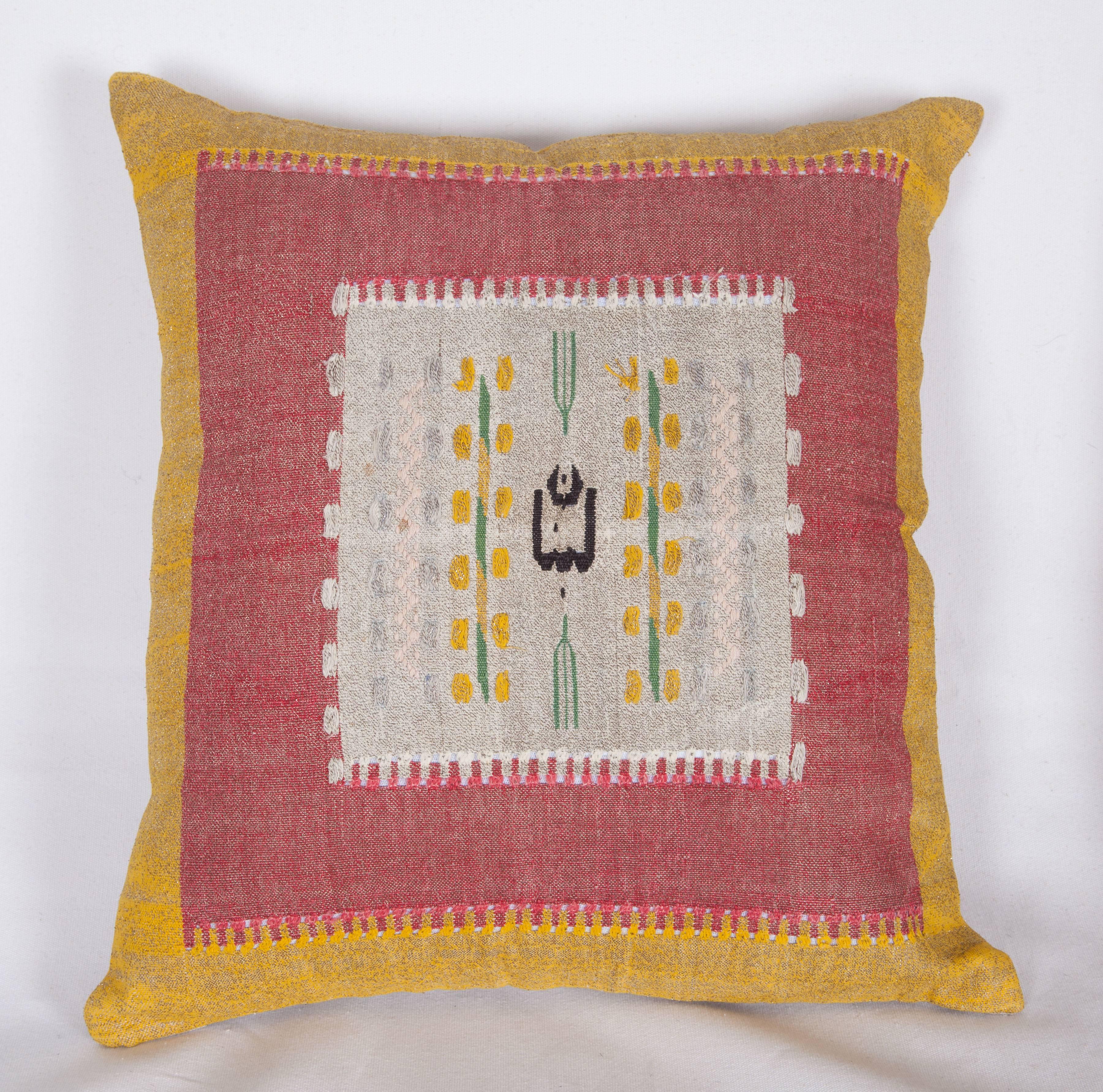 The pillows are made out of an early 20th century, Syrian pillow tops. It does not come with an insert but it comes with a bag made to the size and out of cotton to accommodate the filling. The backing is made of linen. Please note ' filling is not