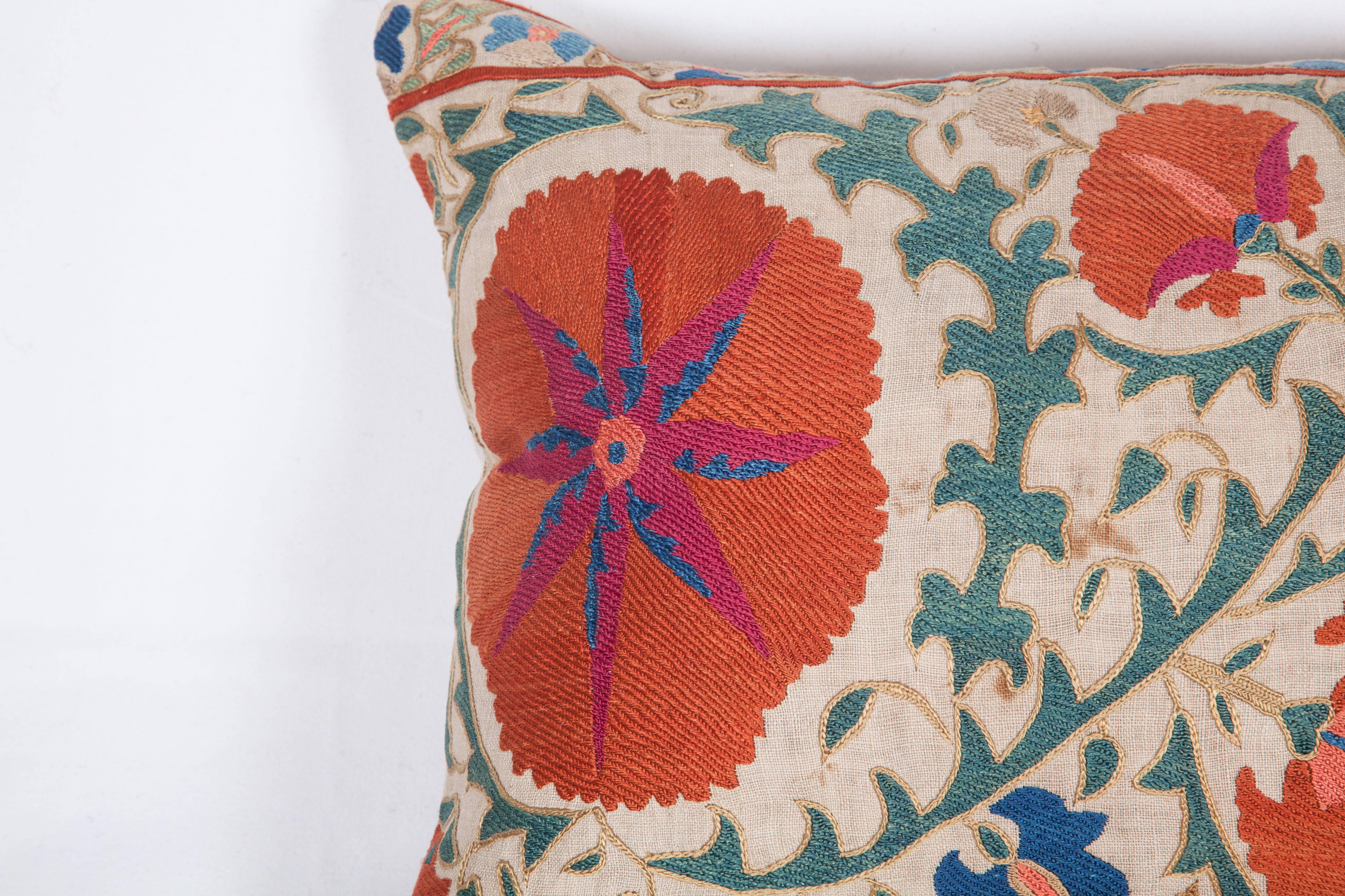 The pillow is made out of amid 19th century, Uzbek Bukhara Suzani. It does not come with an insert but it comes with a bag made to the size and out of cotton to accommodate the filling. The backing is made of linen. Please note 'filling is not
