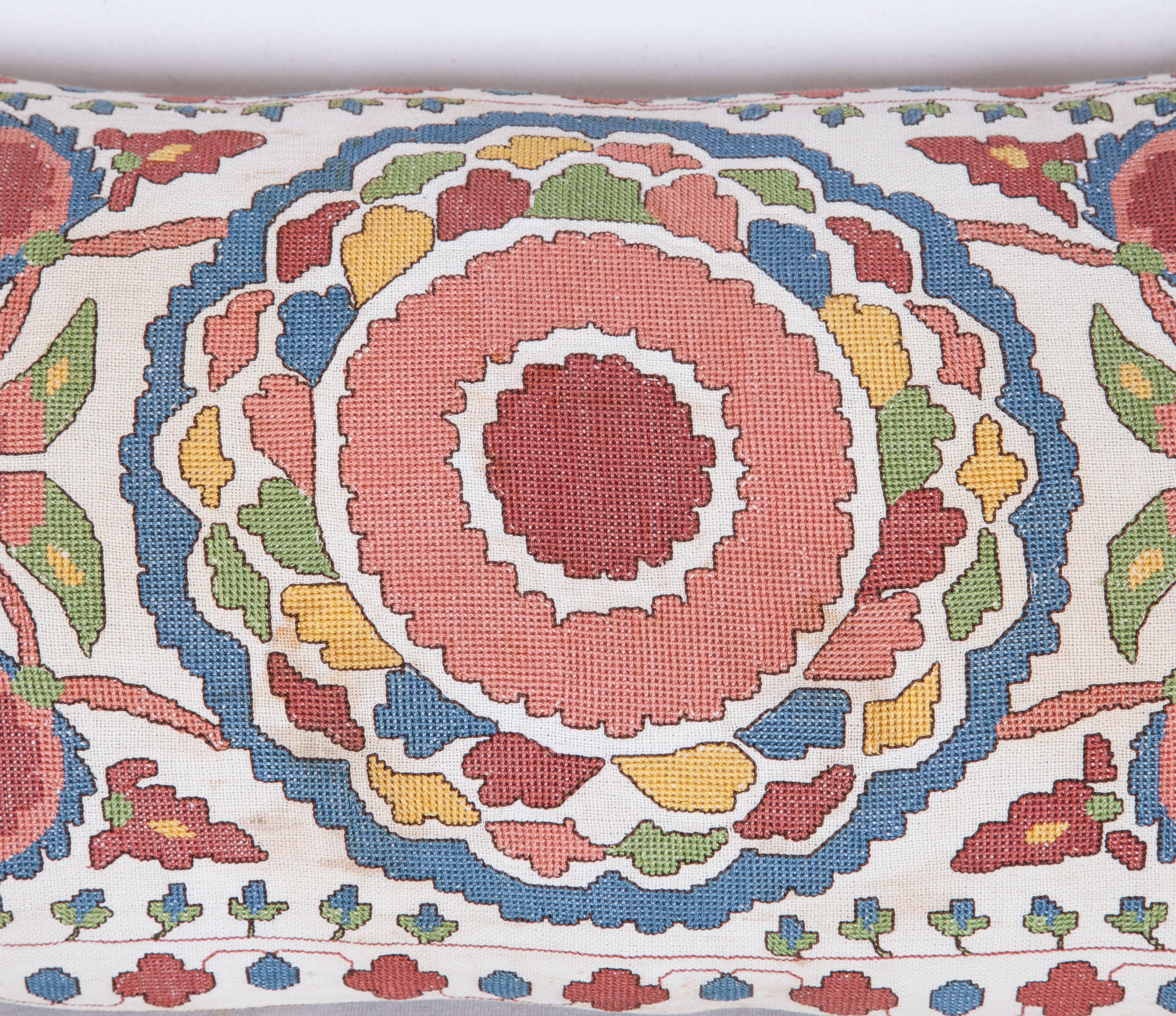 The pillow is made out of an early 20th century. Bulgarian embroidery. It does not come with an insert but it comes with a bag made to the size and out of cotton to accommodate the filling. The backing is made of linen. Please note ' filling is not