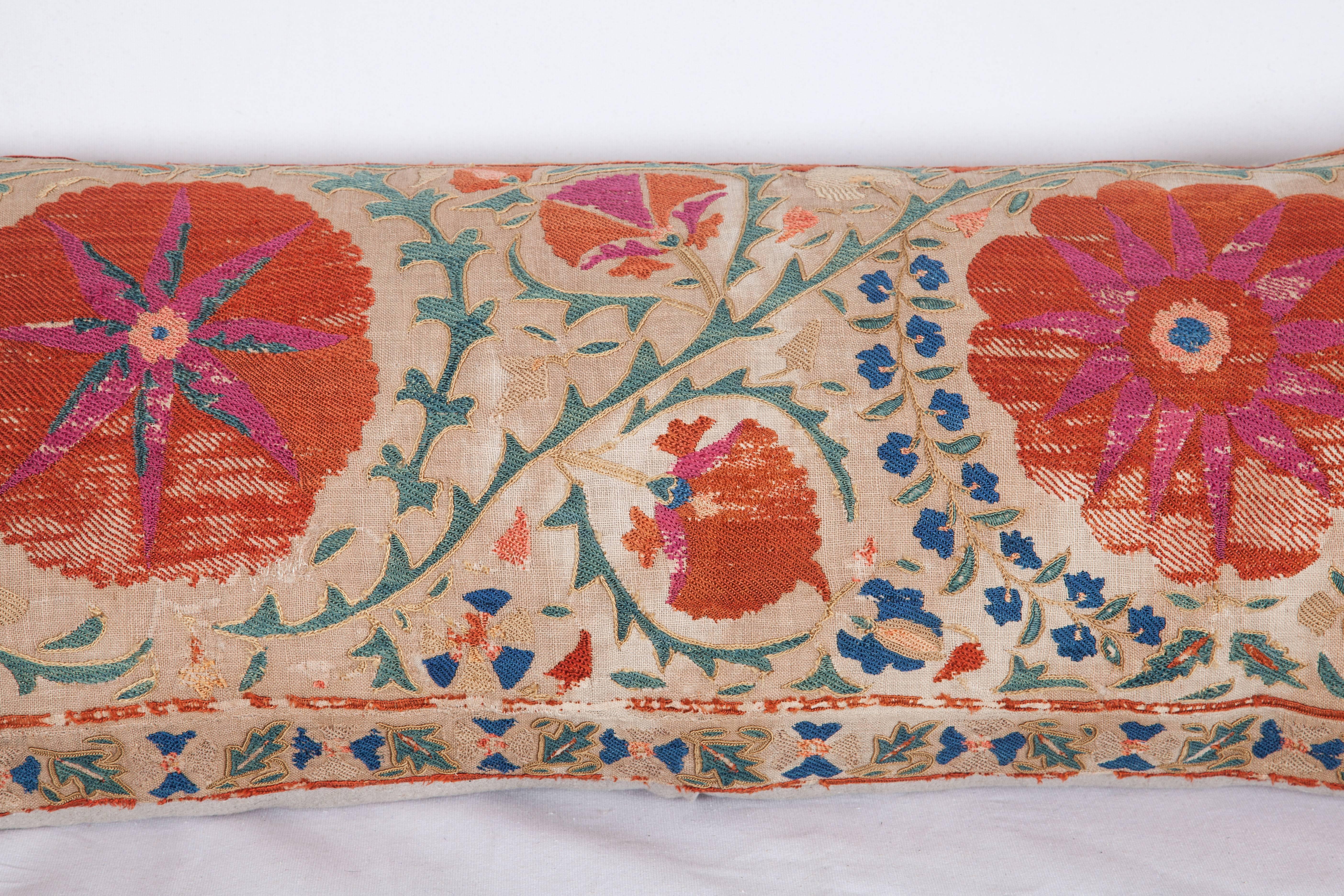 The pillow is made out of a mid-19th century, Uzbek Bukhara Suzani. It does not come with an insert but it comes with a bag made to the size and out of cotton to accommodate the filling. The backing is made of linen. Please note ' filling is not