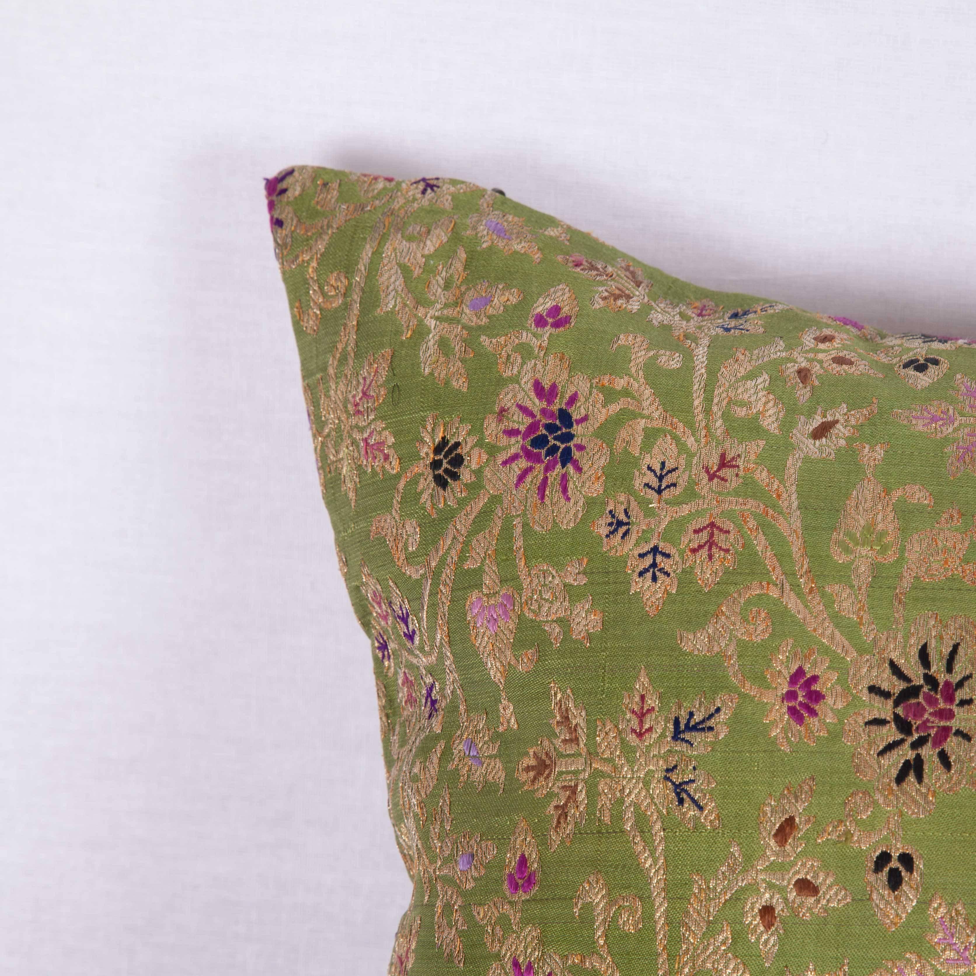 The pillow is made out of mid-19th century, Persian brocade. It does not come with an insert but it comes with a bag made to the size and out of cotton to accommodate the filling. The backing is made of linen. Please note ' filling is not provided'.
