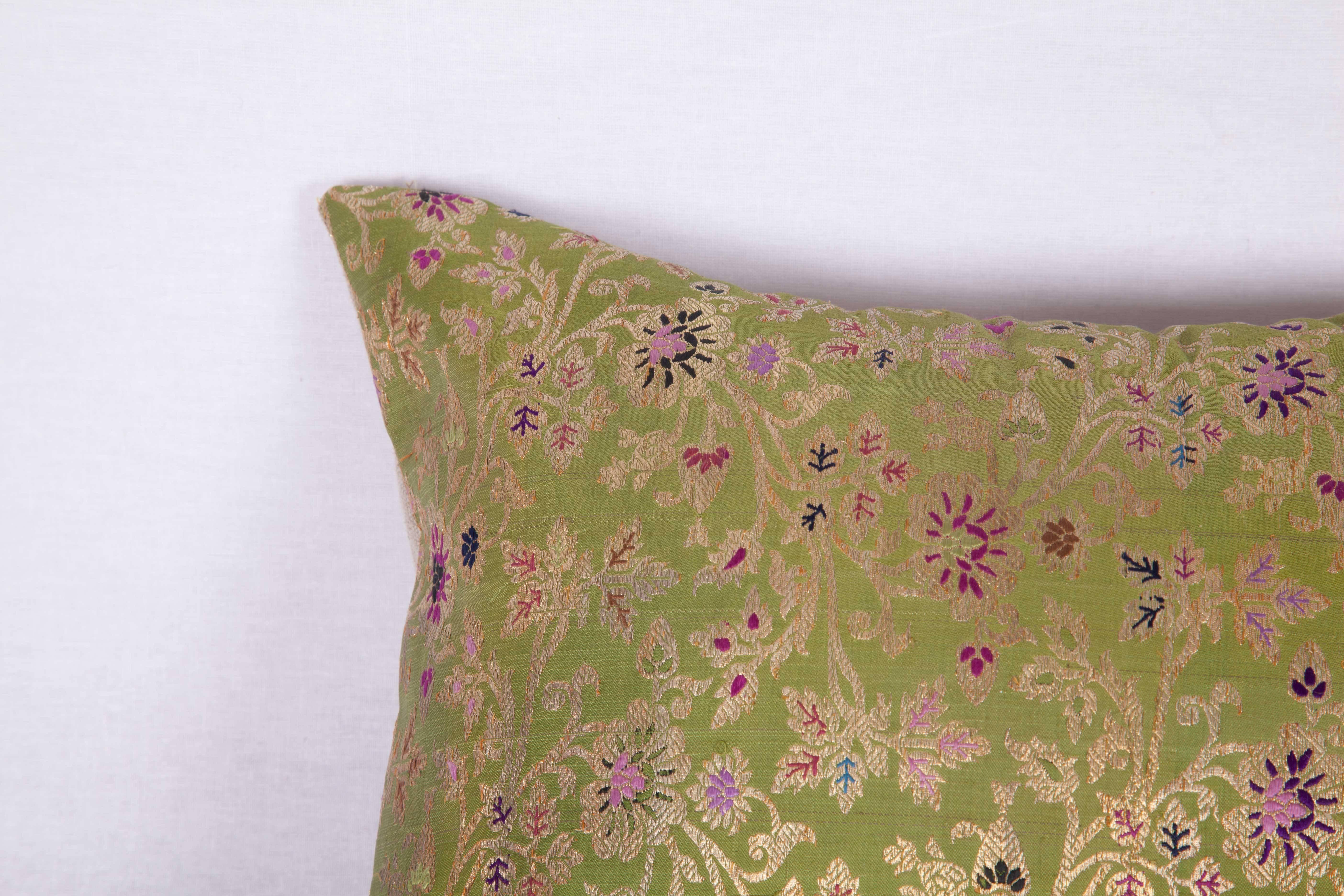 The pillow is made out of mid-19th century, Persian brocade. It does not come with an insert but it comes with a bag made to the size and out of cotton to accommodate the filling. The backing is made of linen. Please note 'filling is not provided'.