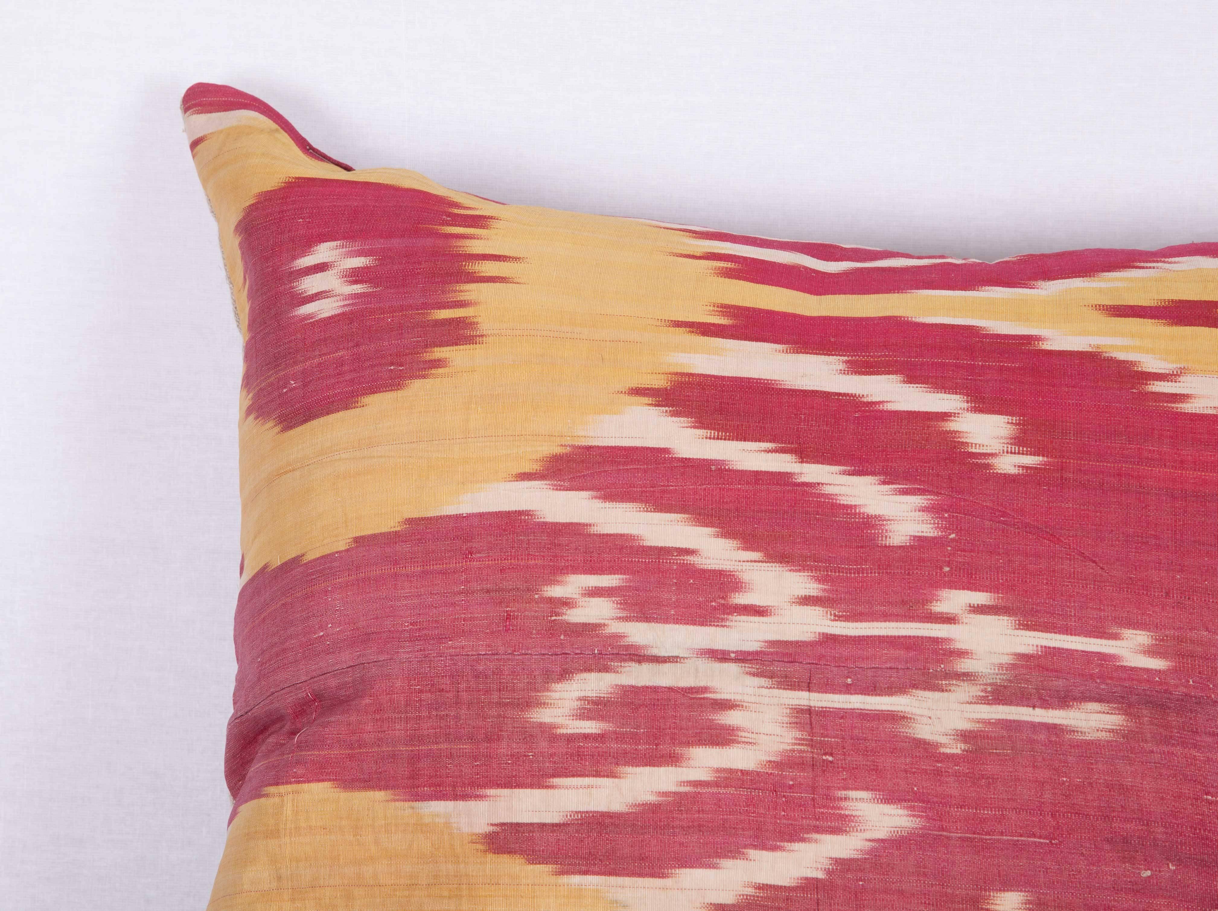 The pillow is made out of late 19th century, Uzbek ikat. It does not come with an insert but it comes with a bag made to the size and out of cotton to accommodate the filling. The backing is made of linen. Please note 'filling is not provided'.