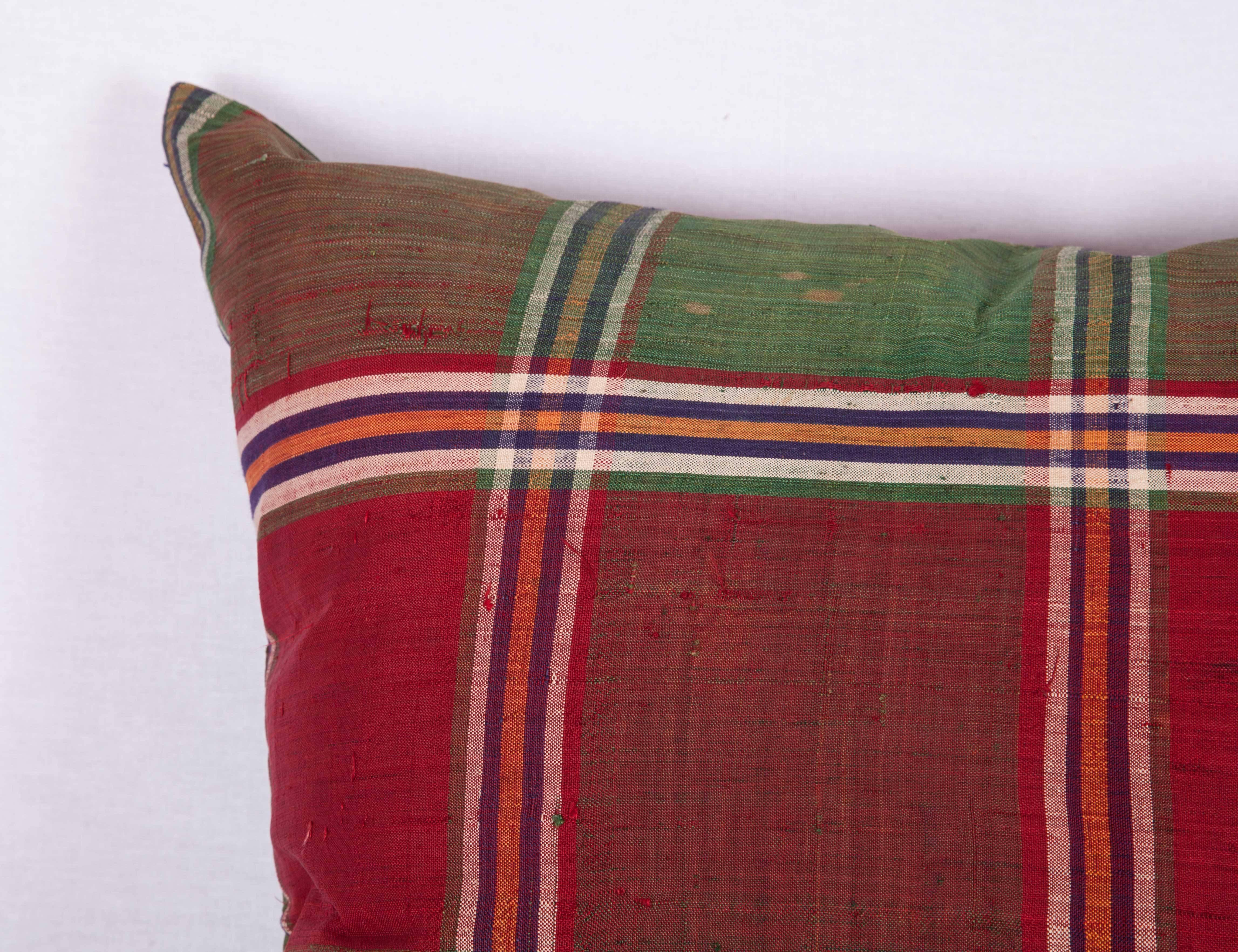 The pillow is made out of mid-20th century, Turkmen silk shawl. It does not come with an insert but it comes with a bag made to the size and out of cotton to accommodate the filling. The backing is made of the same fabric. Please note ' filling is