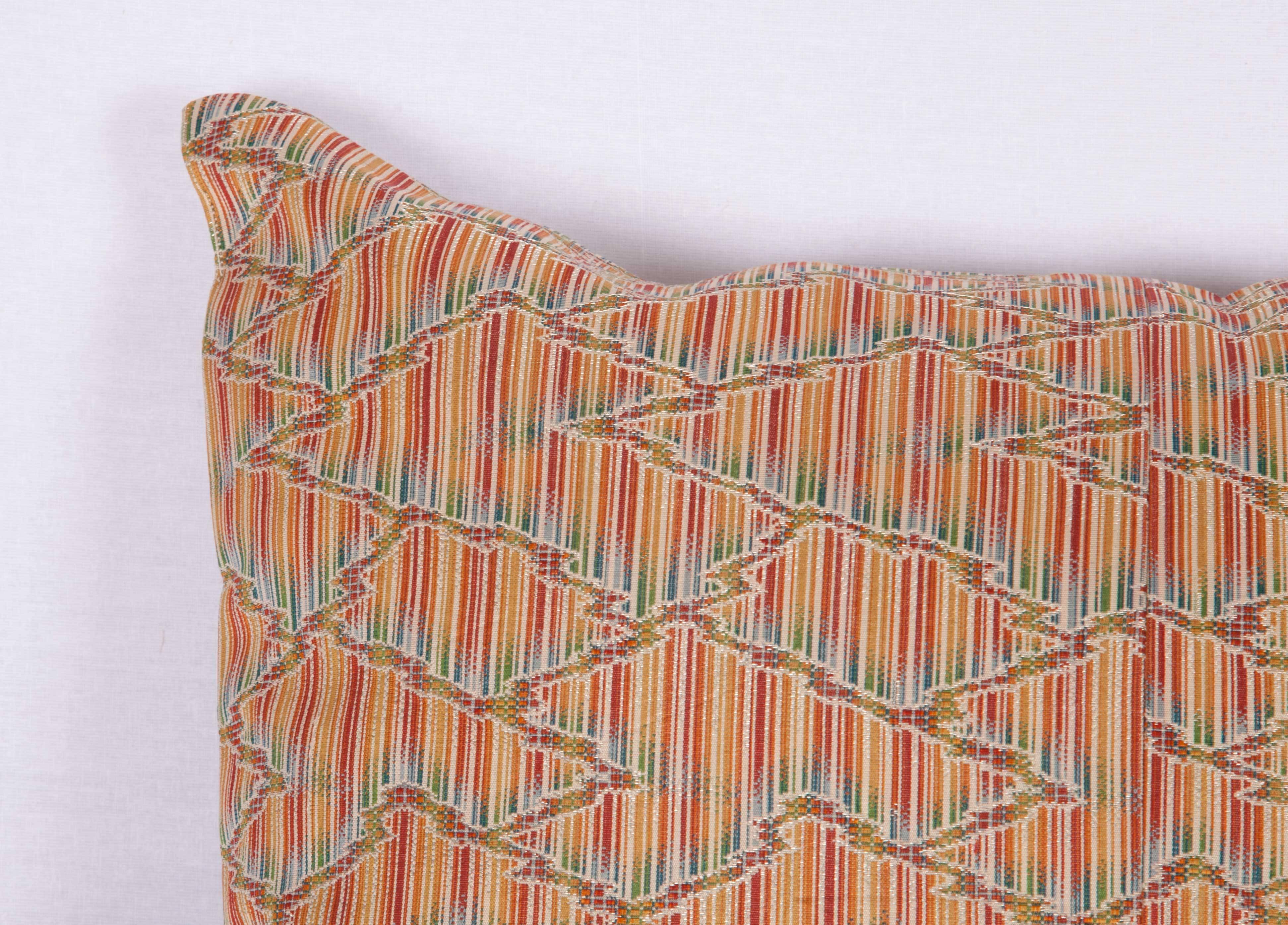 The pillow is made out of mid-20th century, Japanese silk obi. It does not come with an insert but it comes with a bag made to the size and out of cotton to accommodate the filling. The backing is made of linen. Please note 'filling is not