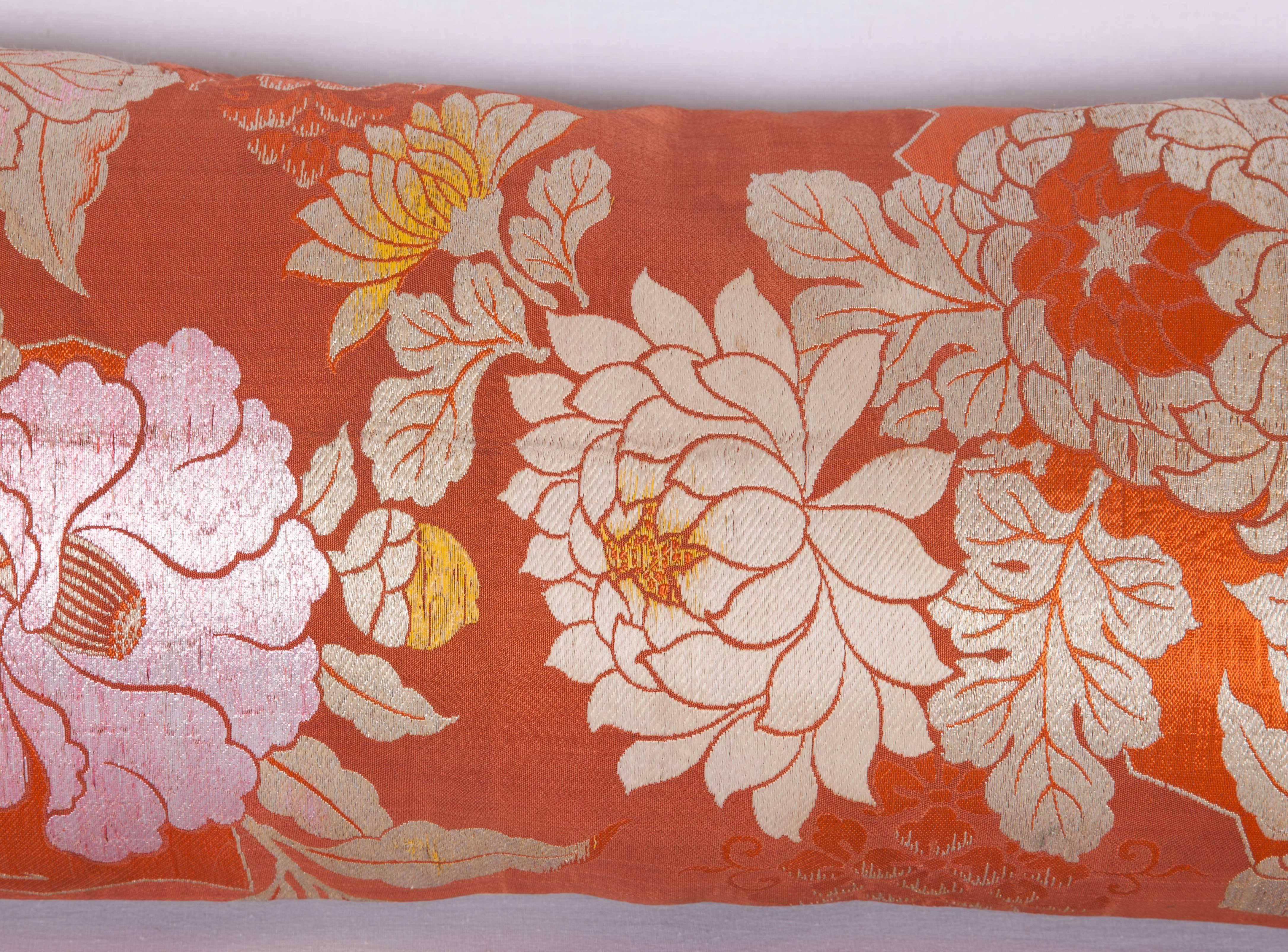 The pillow is made out of mid-20th century, Japanese silk obi. It does not come with an insert but it comes with a bag made to the size and out of cotton to accommodate the filling. The backing is made of linen. Please note ' filling is not
