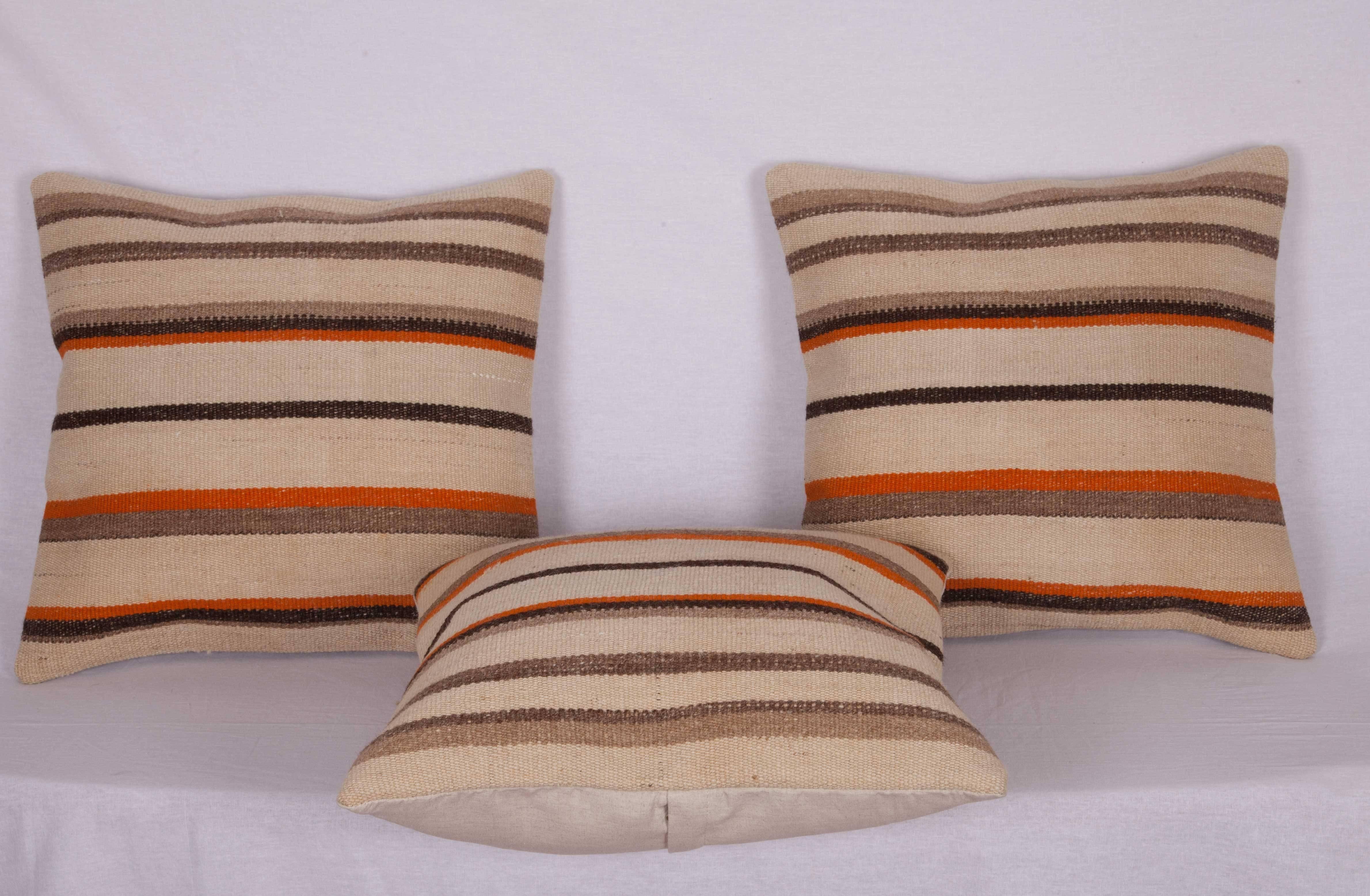 The pillow cases are made out of a mid-20th century, Turkish wool Kilim. They do not come with an insert but they come with a bag made to the size and out of cotton to accommodate the filling. The backing is made of linen. Please note filling is not
