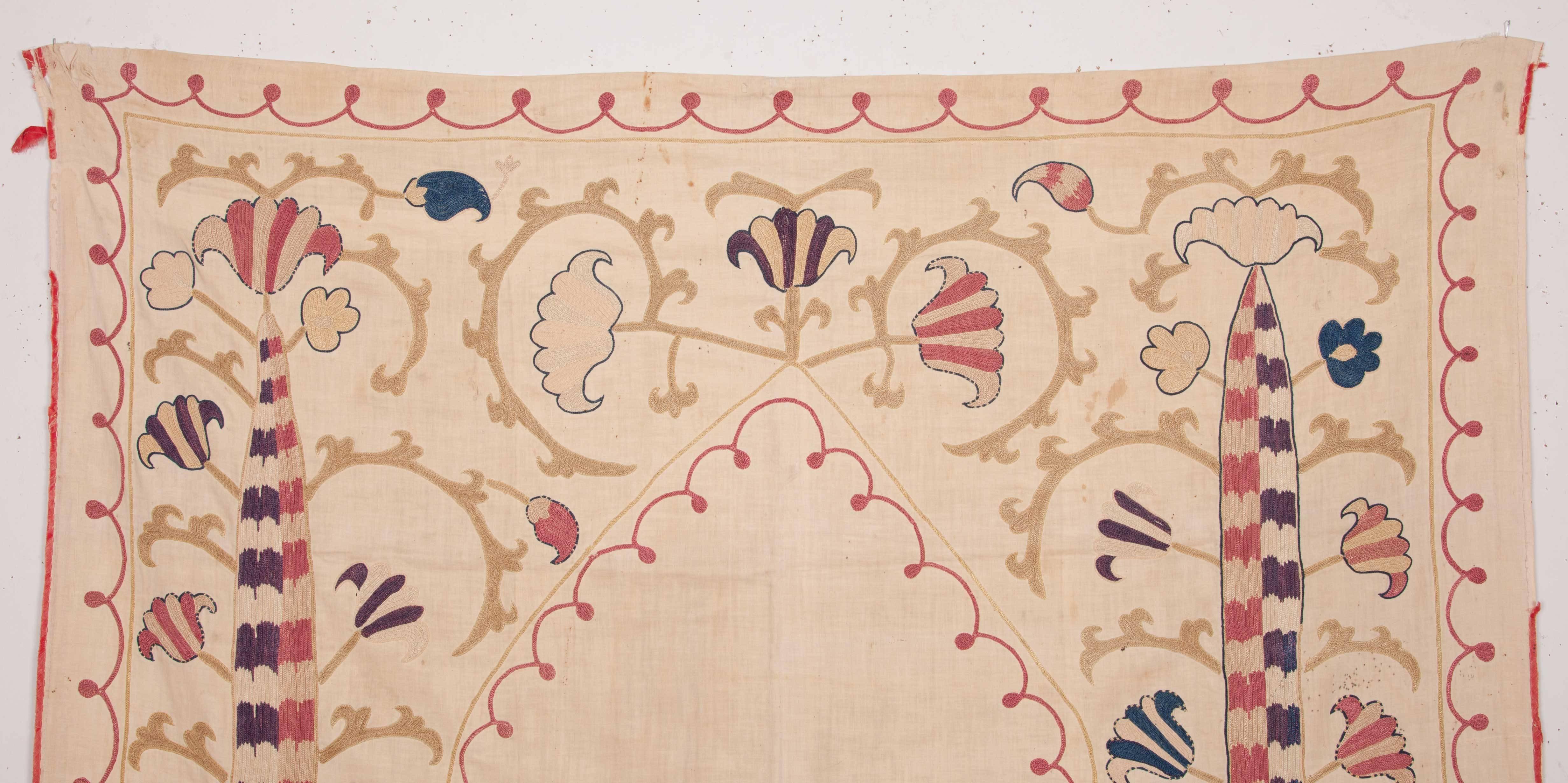This small Suzani displays and unusual design in soft natural colors.