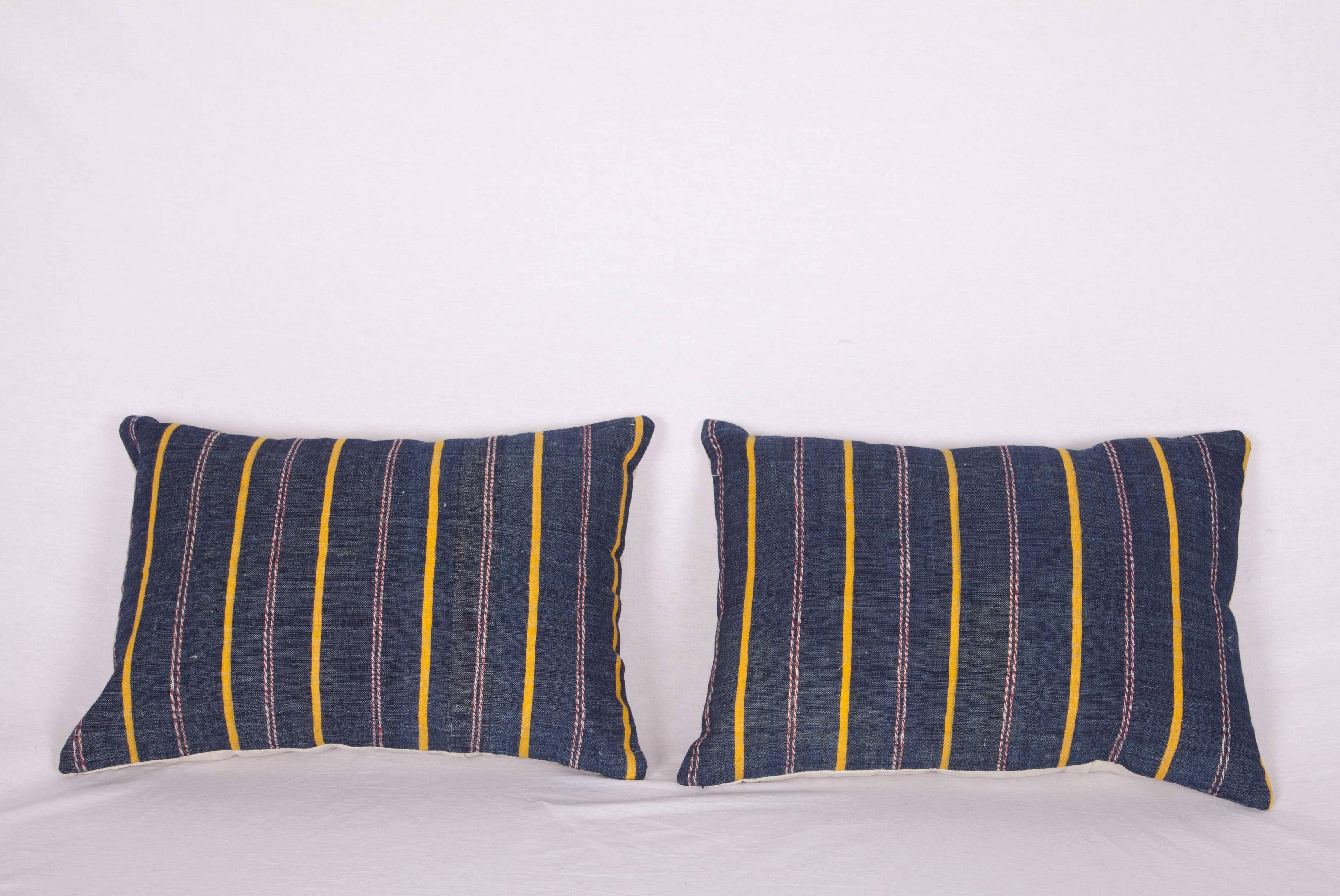 The pillows are made out of a mid-20th century, Turkish Kilim. They do not come with an insert but they come with a bag made to the size and out of cotton to accommodate the filling. The backing is made of linen. Please note filling is not provided.