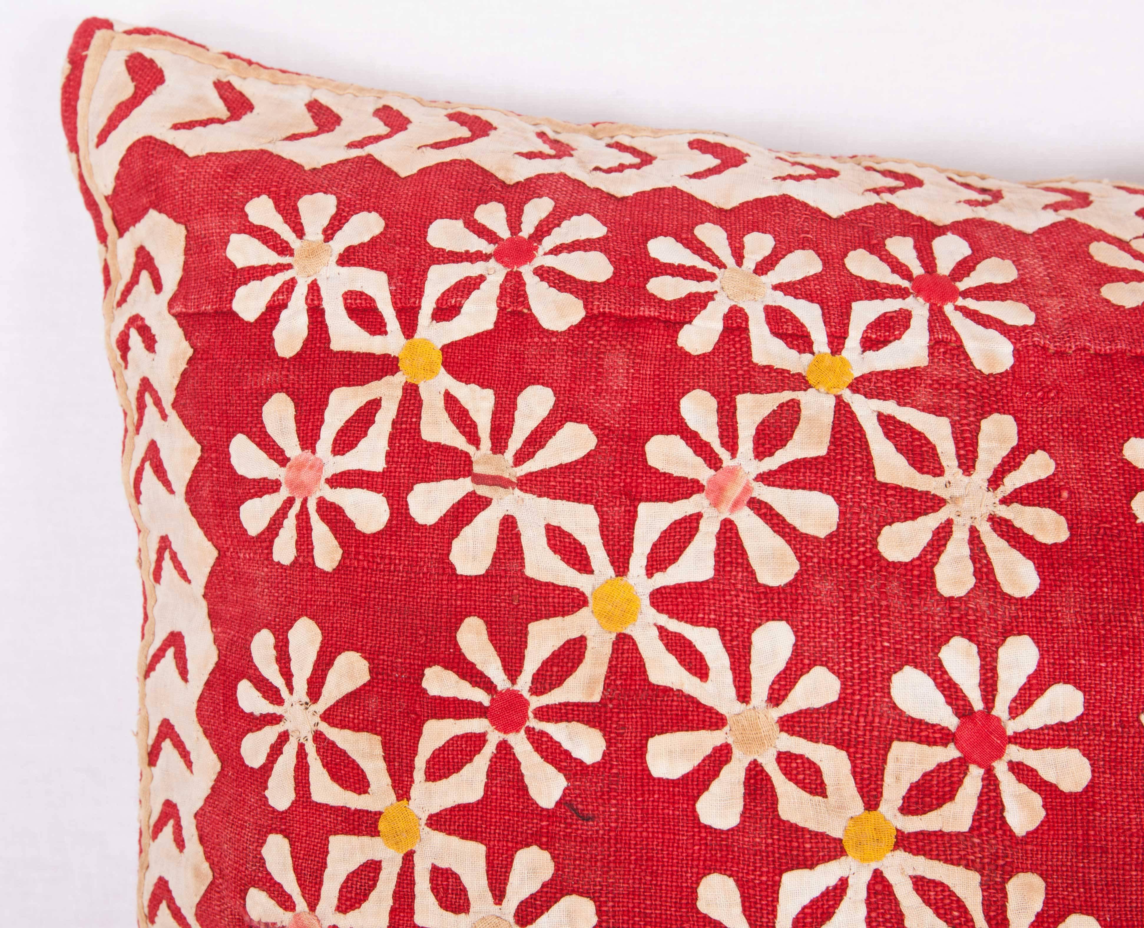 The pillow case is made from an early 20th century Indian applique panel. It does not come with an insert but comes with a bag made to the size and out of cotton to accommodate the filling. The backing is made of linen. Please note filling is not