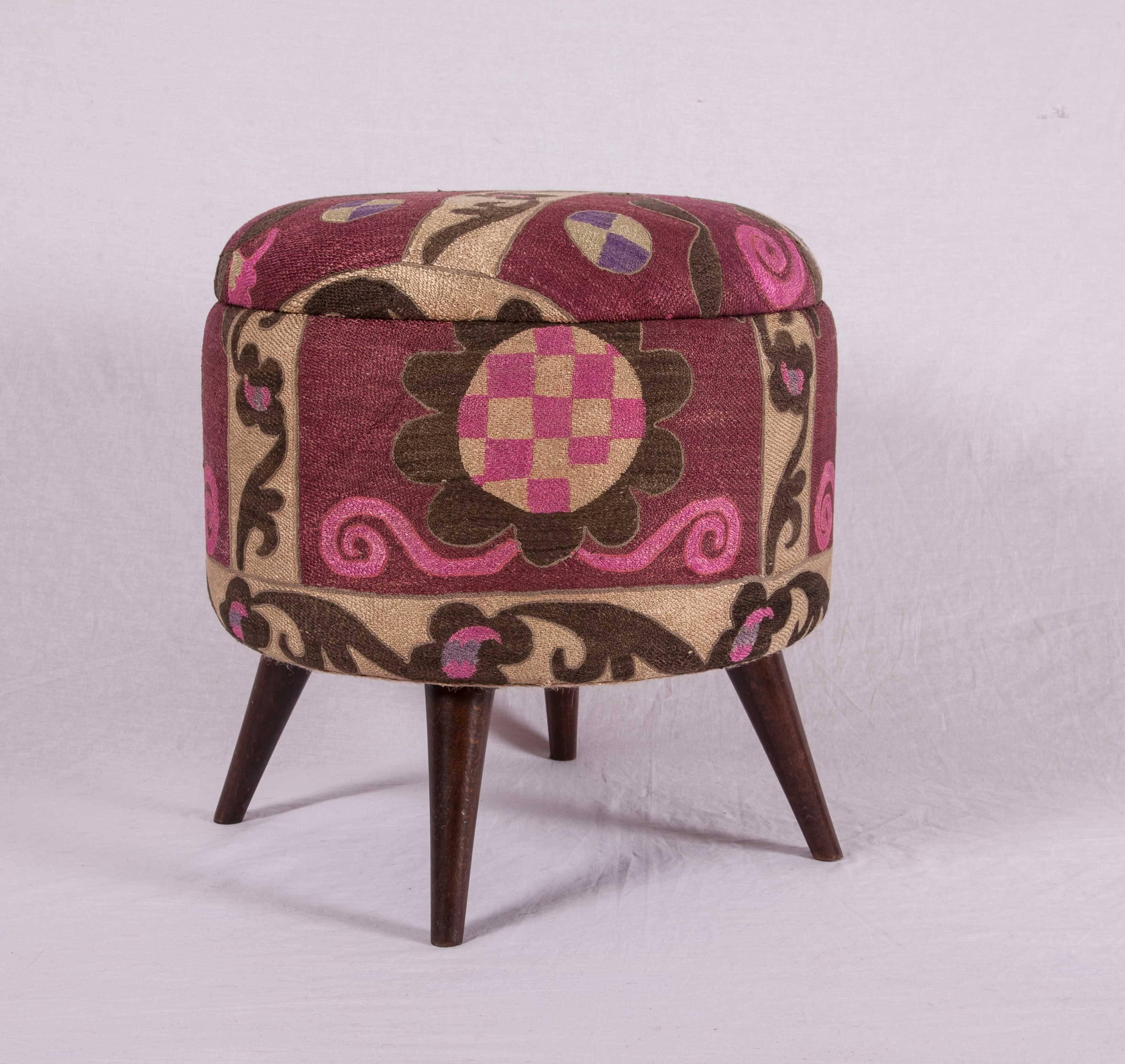 Ottoman or poufs upholstered in a vintage silk suzani from Tashkent, Uzbekistan.