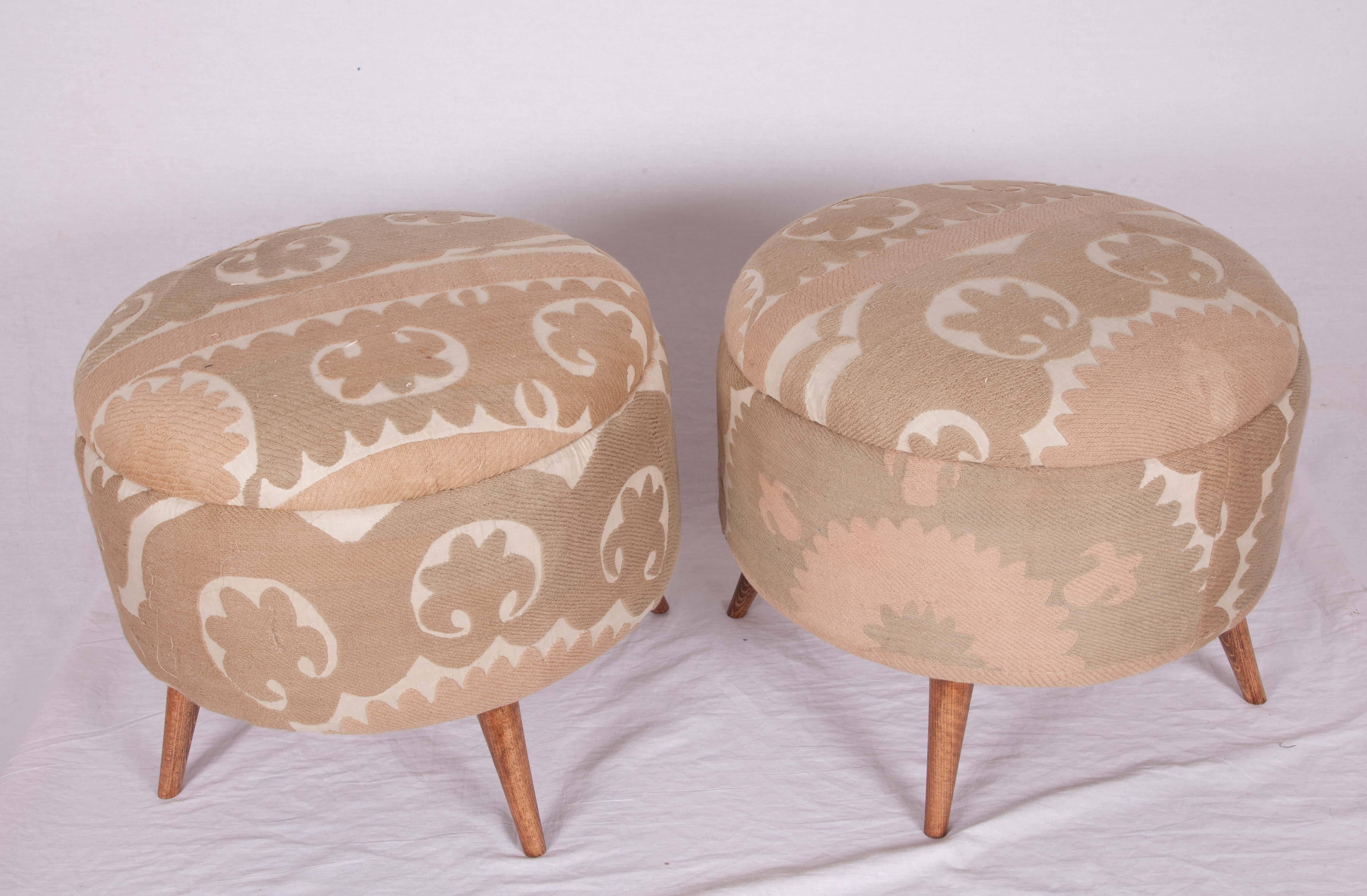 Ottoman or poufs upholstered in a vintage silk Suzani from Samarkand, Uzbekistan.