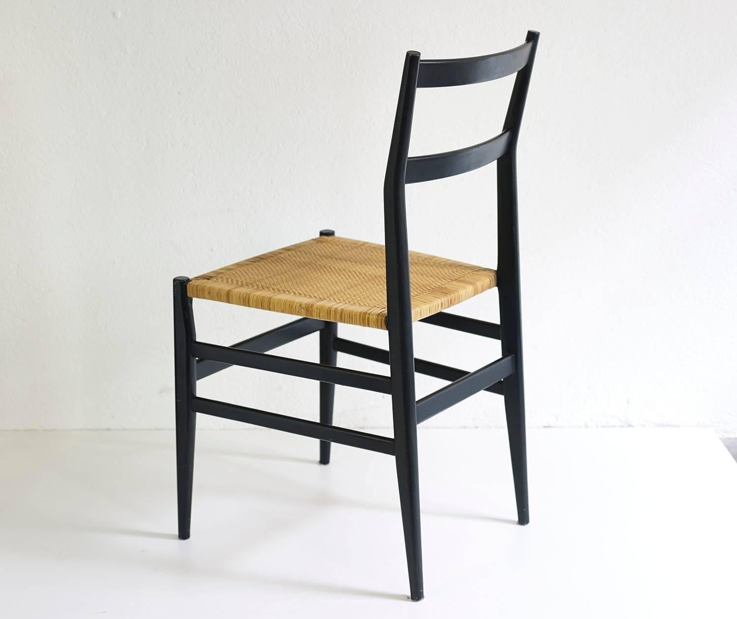 Early and hard to find fully original set of eight Leggera chairs in black lacquered wood and cane.

Very good condition with wear consistent with age and use. 

Some chairs still bear their original label.

Additional pictures on request.