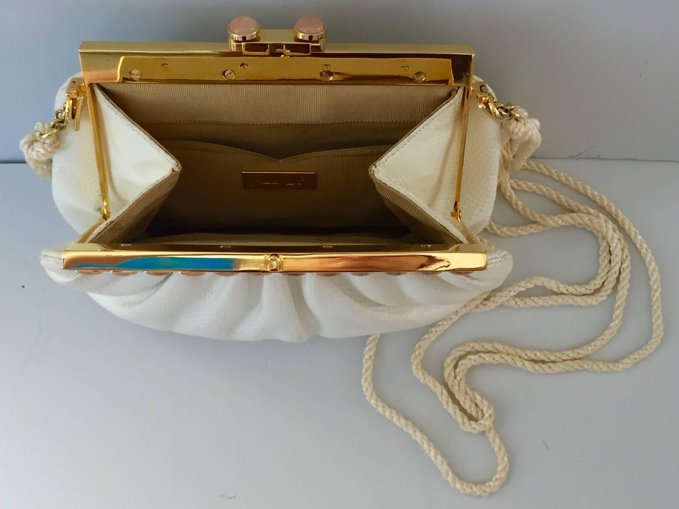 Signed Judith Leiber white handbag made of lizard skin and adorned, with semi-precious cabochon set stones in yellow, green and purple set in gold overlay and two pink stones on the clasp. Includes gold plated brass mirror, comb, and coin purse as