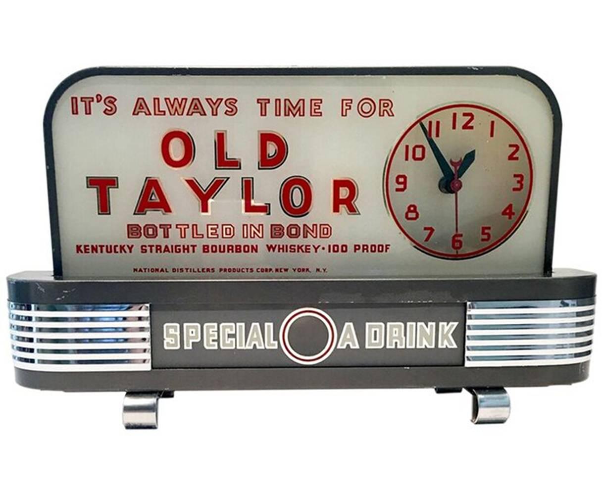 Extremely rare Art Deco Bond & Lillard Old Taylor whiskey bar topper advertising clock and light sign. The front of the piece is glass and features beautiful Art Deco styling with chrome grill details. The housing of this piece is pressed steel.