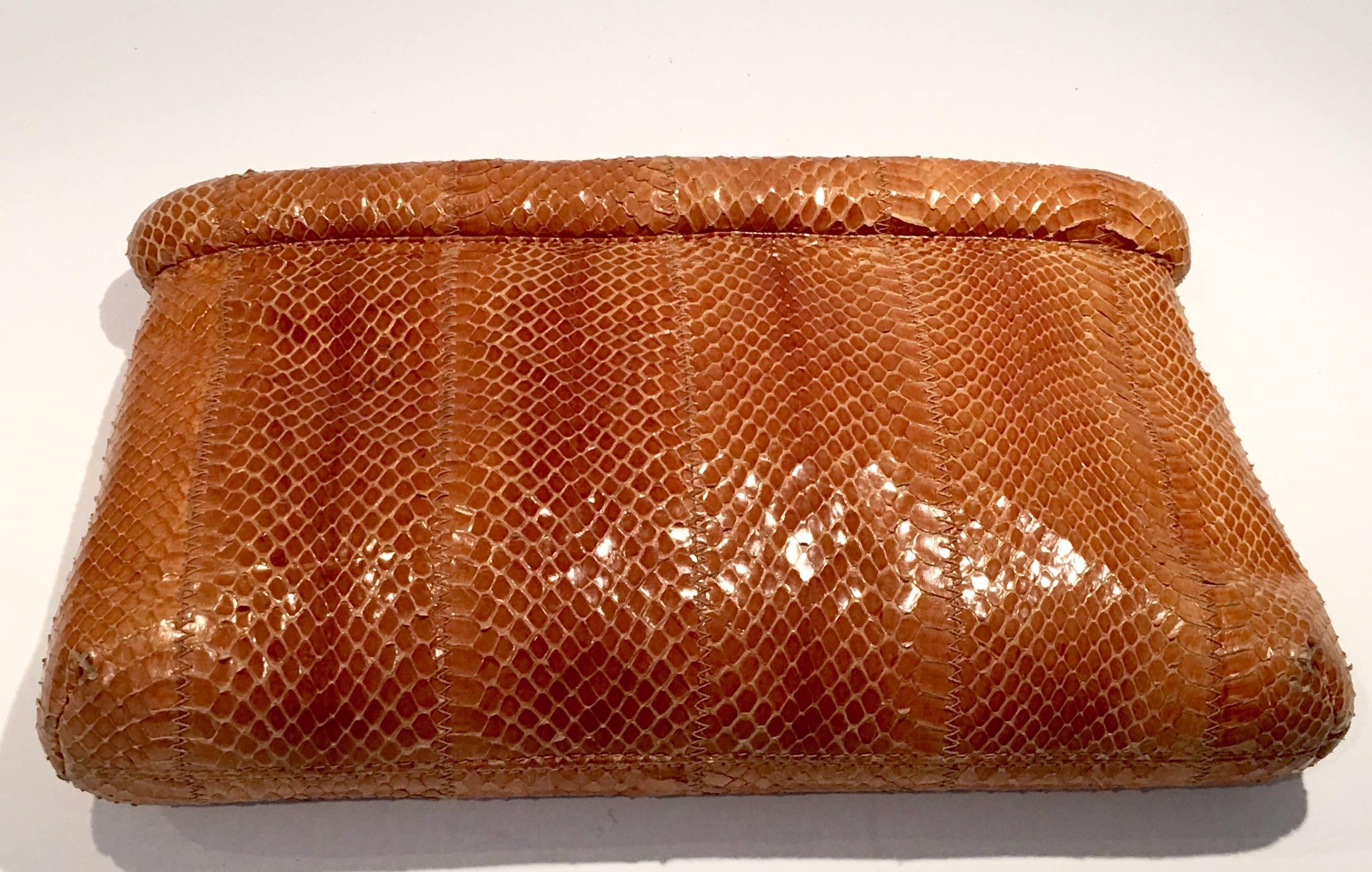 1980s Caramel colored snakeskin envelope style clutch handbag designed by
Susan Gail and made in Spain. Handbag is lined in suede and has one interior pocket with zipper closure.