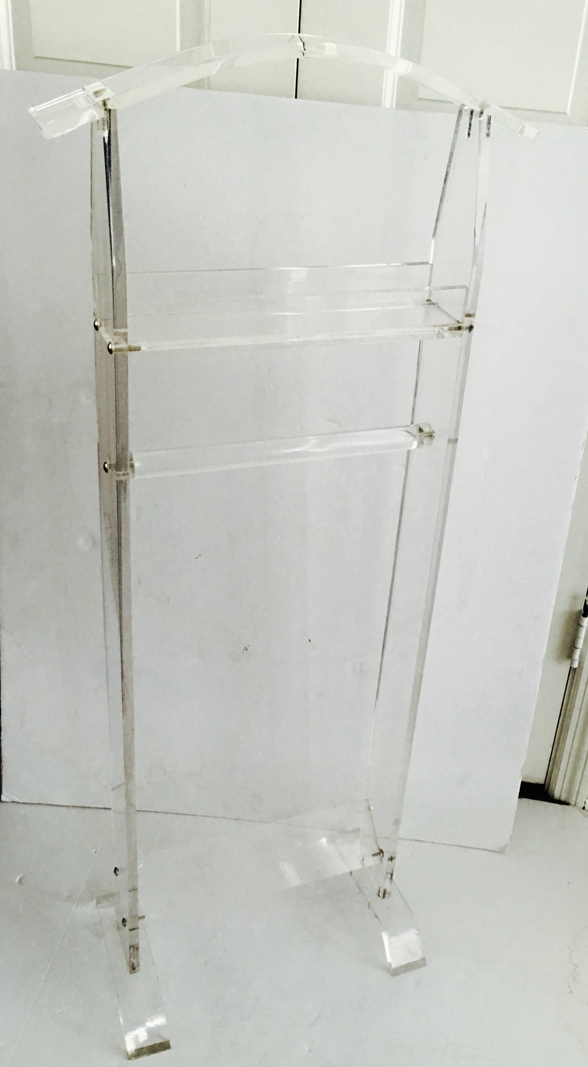 1970'S tall valet made of solid slab Lucite. Minimalist design and great lines. Features chrome hardware with a cross bar to hang pants, a coat rack and catch shelf.