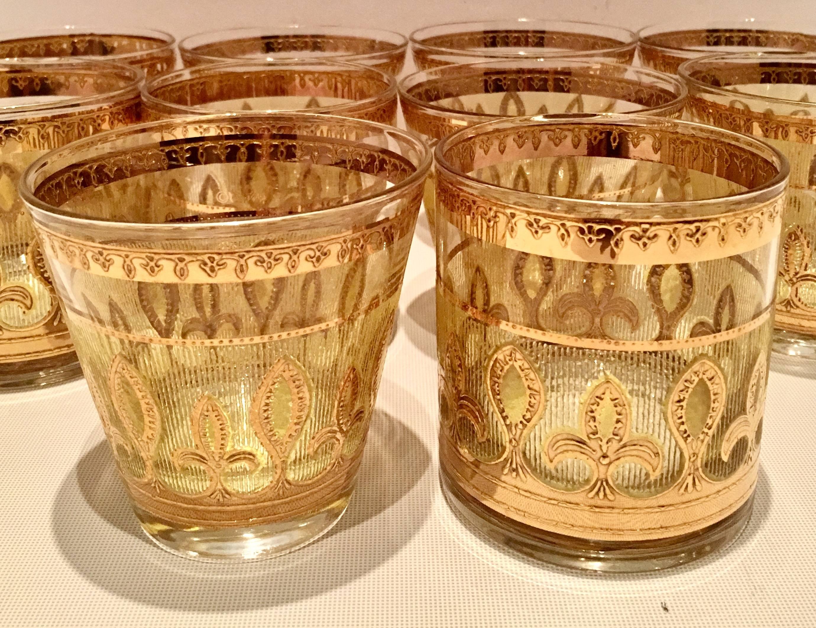 Culver Ltd. set of ten green and 22-karat gold embellished fleur-de-lis motif drink glasses. Set includes six double old fashion glasses and four rocks glasses, 3.5