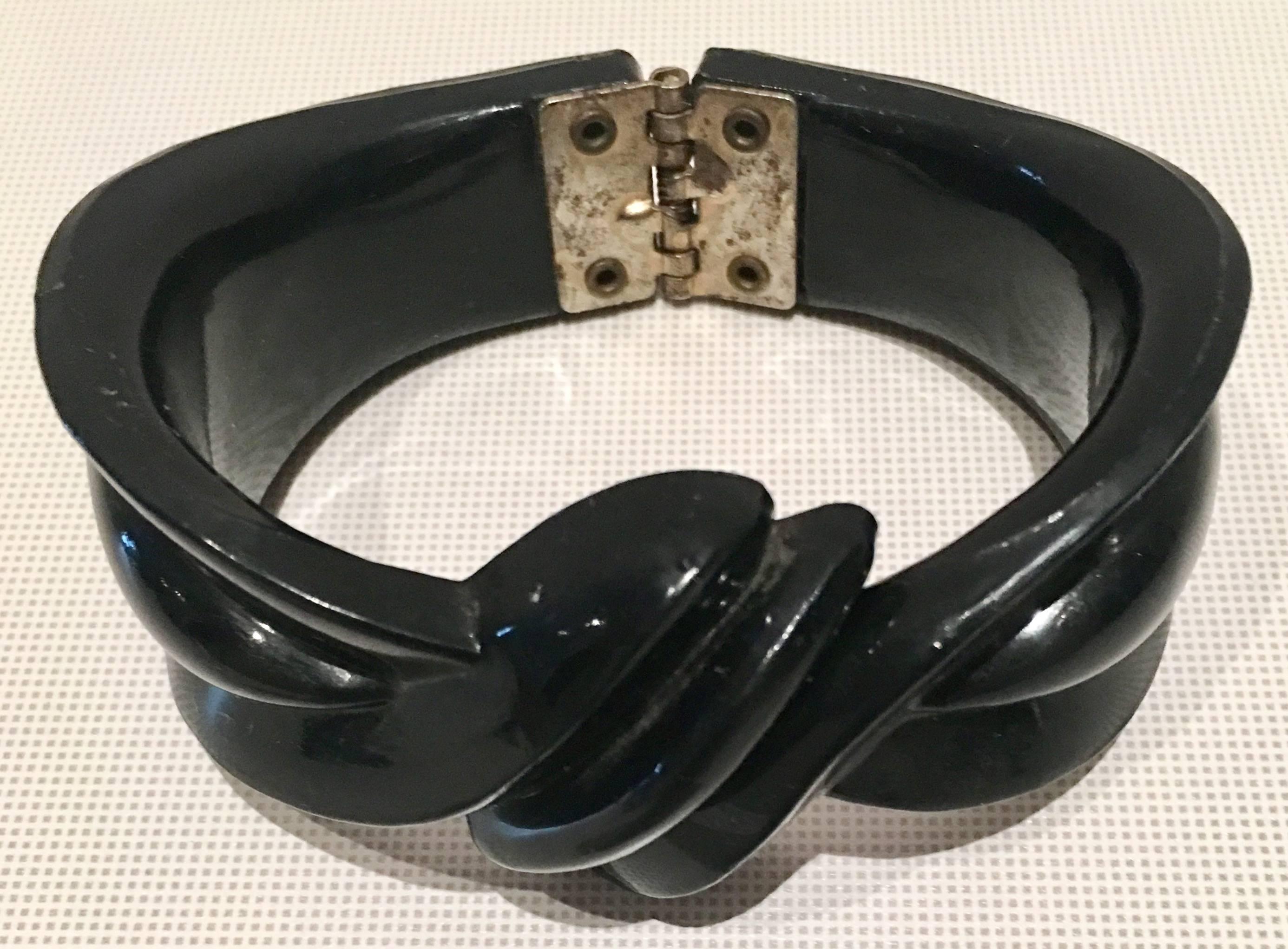 1940s deeply carved thermoplastic jet black clamper bracelet with silver tone metal. Internal diameter measures, 2.5" inches.
   