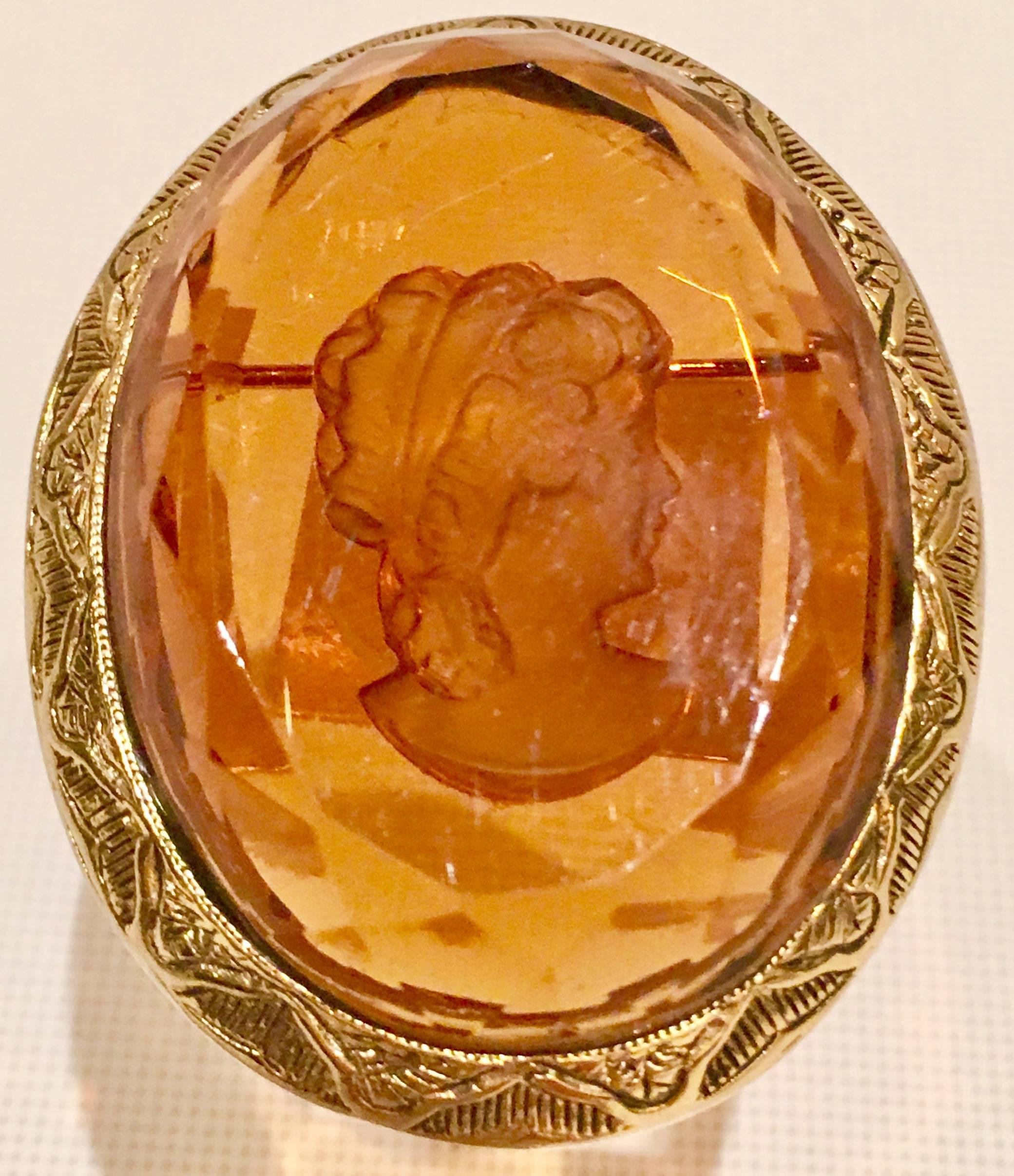 Mid-Century carved and faceted glass cameo, female facing right set in a gold wash bezel set brooch or pin.