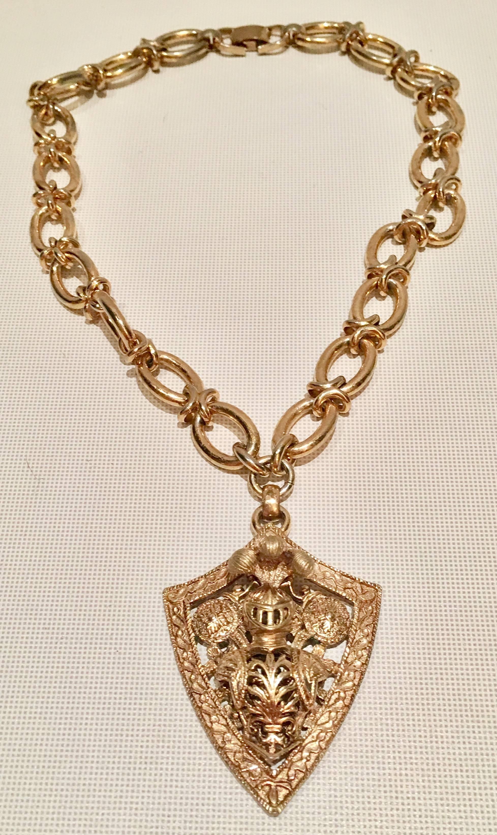 Fantastic three dimensional gold plate chunky chain necklace and knights shield pendant necklace signed. Bergere. Necklace with pendant measures 18