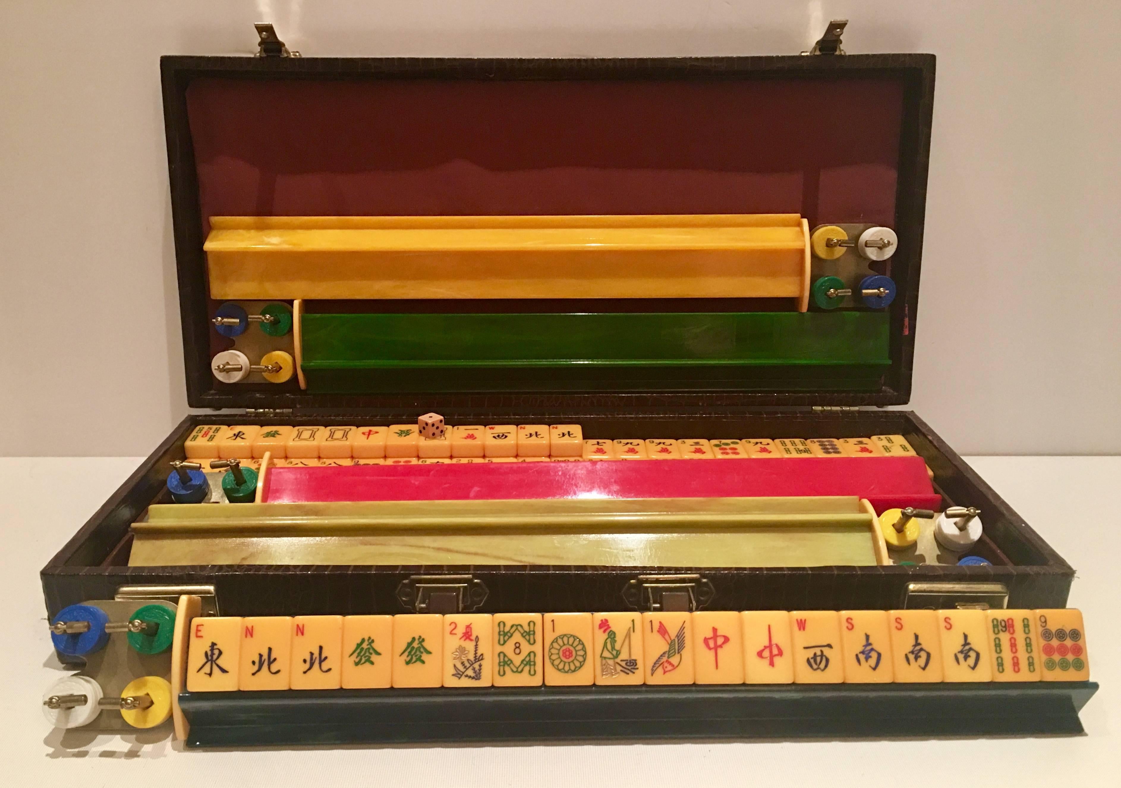 1920s Bakelite Mahjong game. Presented in a beautiful brown leatherette exotic skin with brass hardware locking briefcase with three interior storage or organization trays. Set includes, two books, 