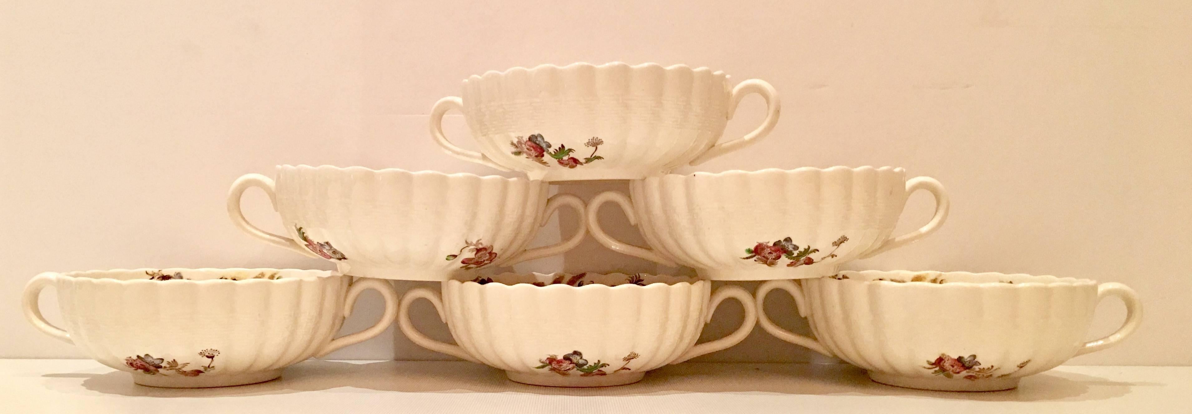 Set of six signed Copeland Spode "Wicker Lane" pattern cream soup bowls. Features and off-white ground with a floral bouquet motif with basket weave detail and scalloped edge. Each piece is signed on the underside.