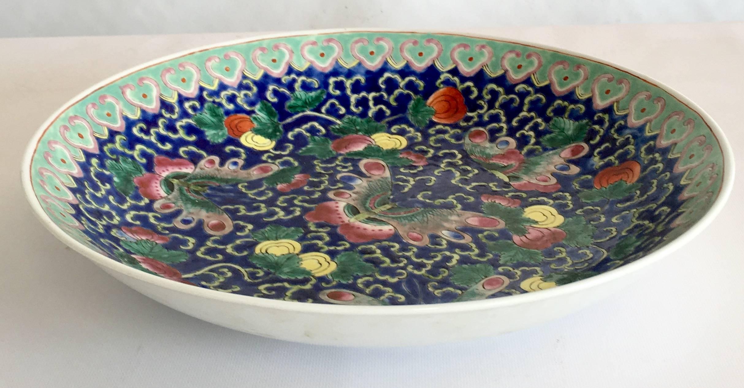 Early 20th century large Chinese export famille butterfly shallow bowl with gold edge. Hand-painted with a vibrant and vivid blue ground and turquoise border.