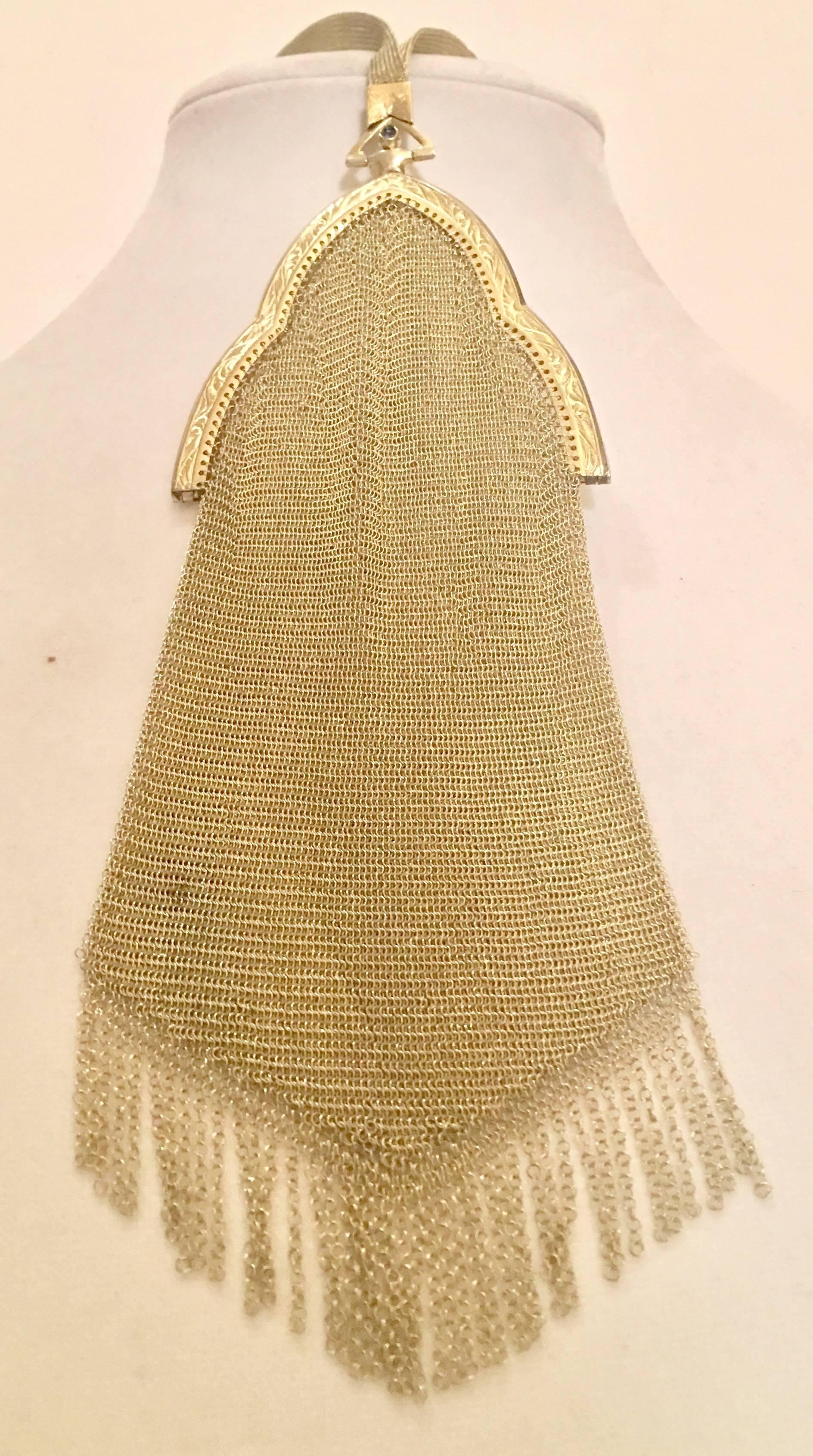 Early 1900s signed Whiting & Davis gold vermeil soldered mesh evening bag signed. This rare collectors bag features a blue sapphire embellished clasp, a mesh adjustable wristlet strap with floral scroll work on the stationary and movable pieces