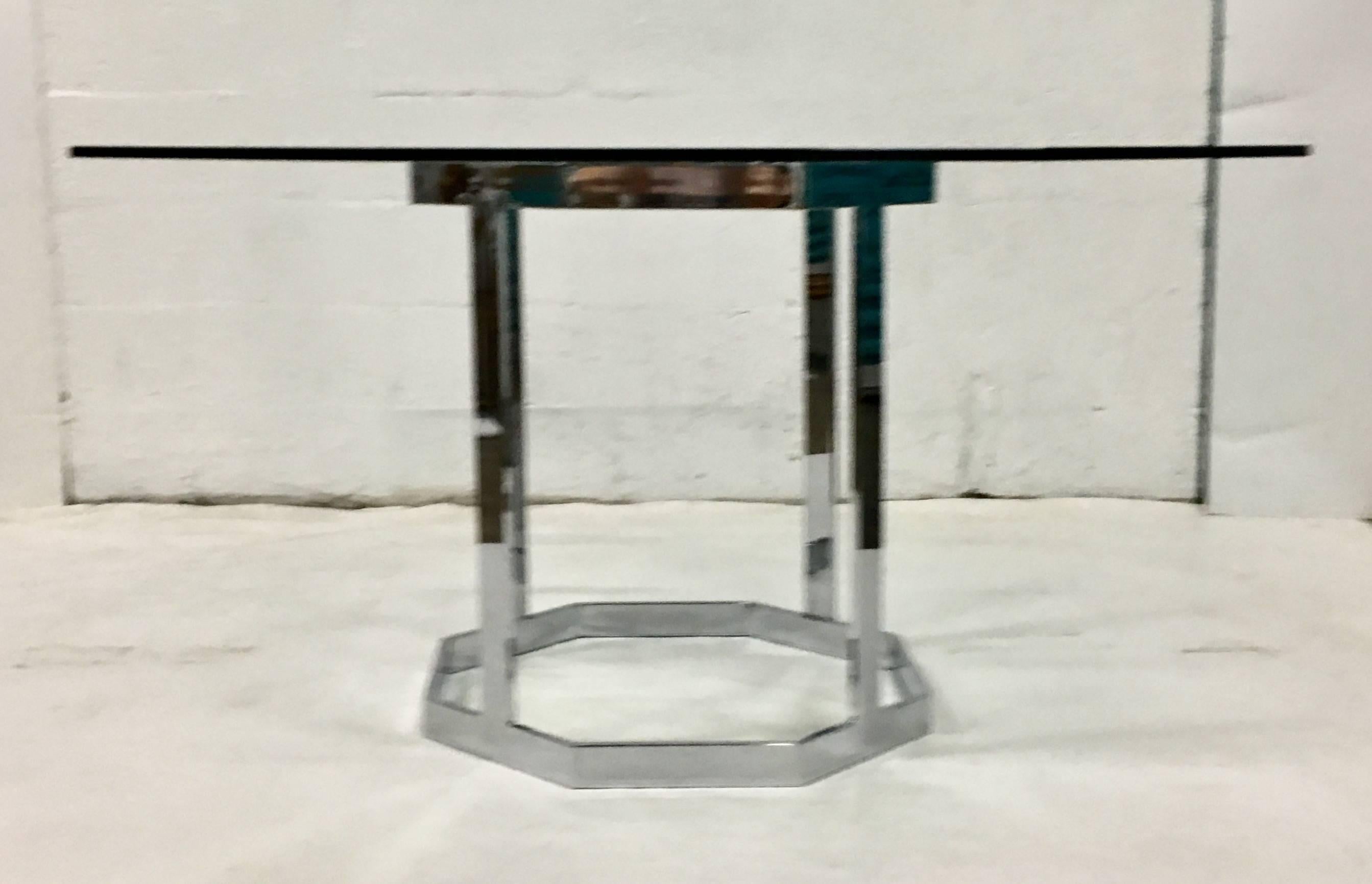 Mid-Century Modern Milo Baughman style chrome flat bar octagon dining table.Includes custom cut octagon shaped glass top, .50" inch thick. Base measures 25" diameter and 28" inches in height.
