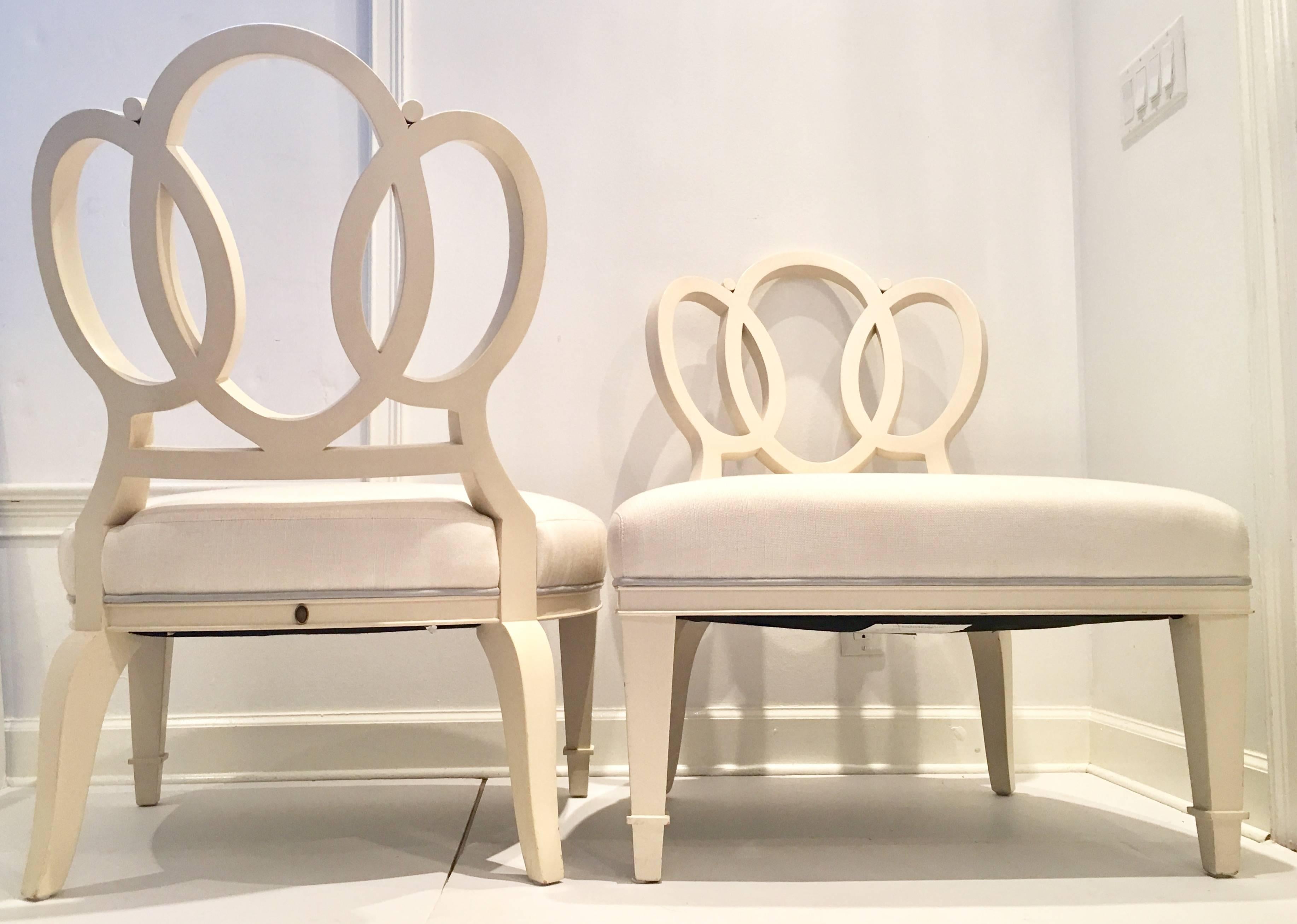 Rare pair of Barbara Barry designed for Henredon "Bracelet Chairs". Made of wood and painted in an off-white semi-gloss finish. Upholstered in white linen blend fabric with a light blue suede welt detail. Each chair is signed on the back
