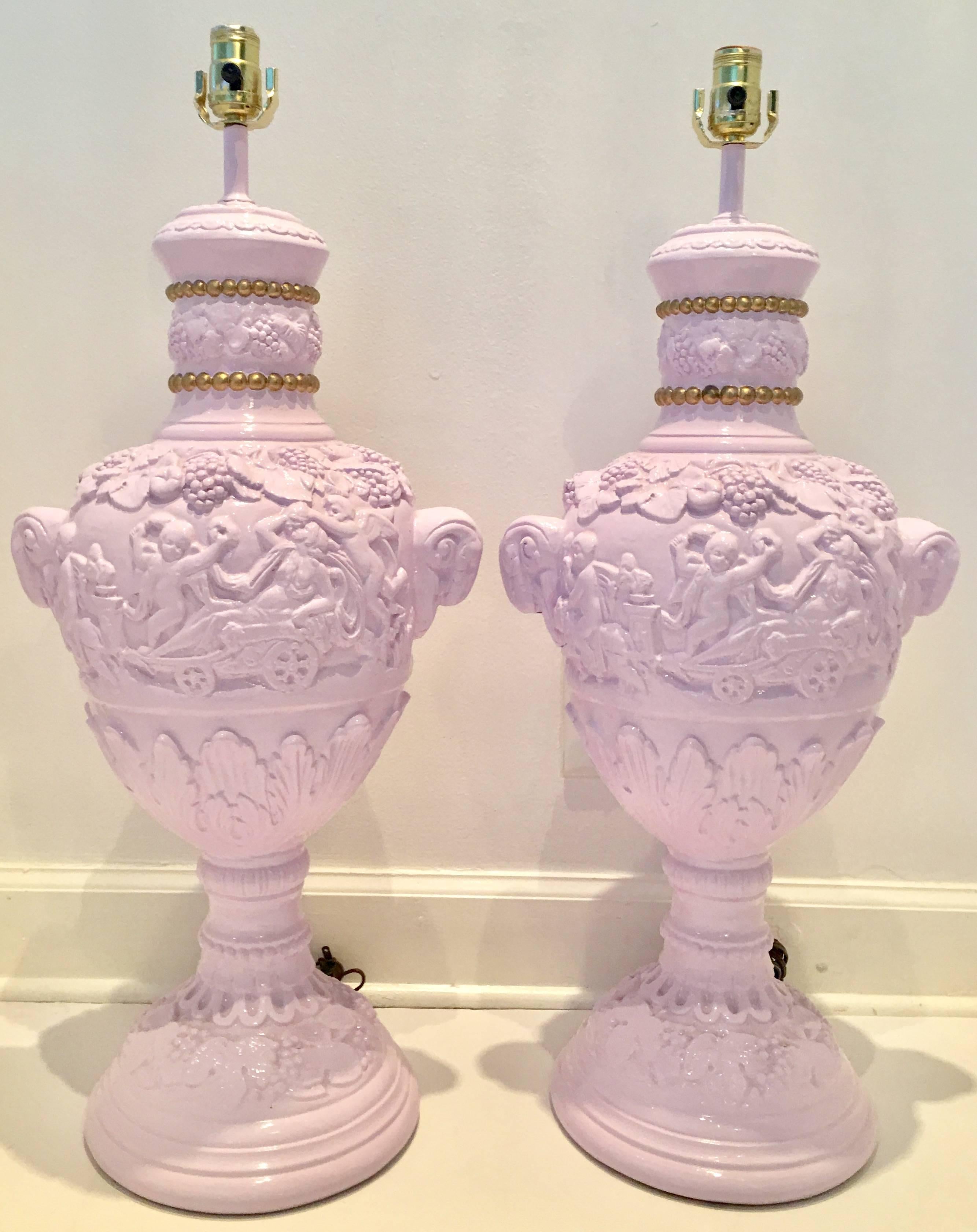 Amazing Pair of 1960s custom lacquered and hand-painted gold beaded detail chalkware lamps. Features, cherubs playing musical instruments with chariots fruit and figural ram's head s on each side of each lamp. Custom lavender high-gloss lacquer