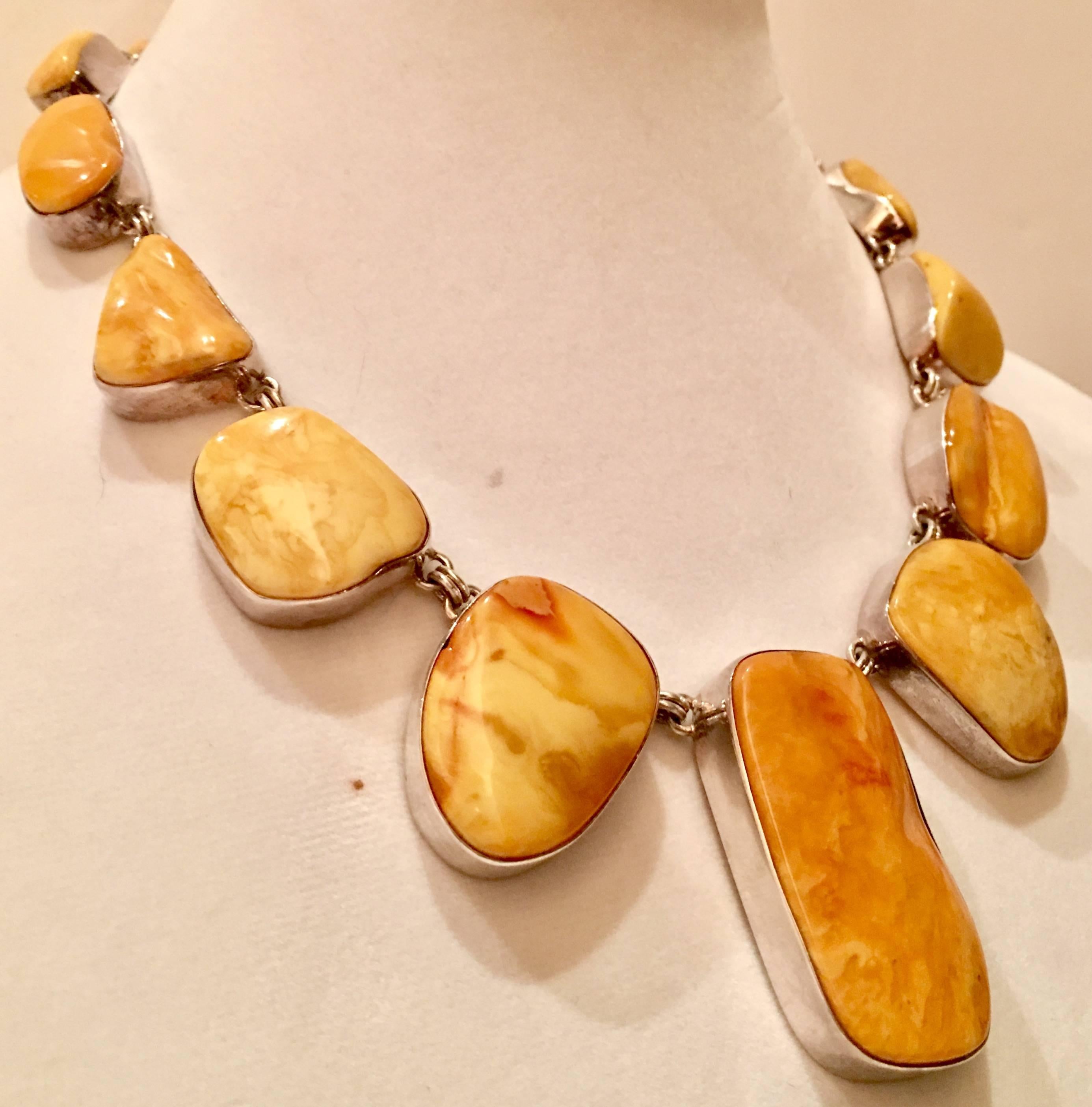 Gorgeous and chunky sterling silver and baltic butterscotch polished amber stone statement necklace. Necklace features fifteen amber stones ranging in size from, 1" inch-2" inch diameter. Total weight 114 grams.