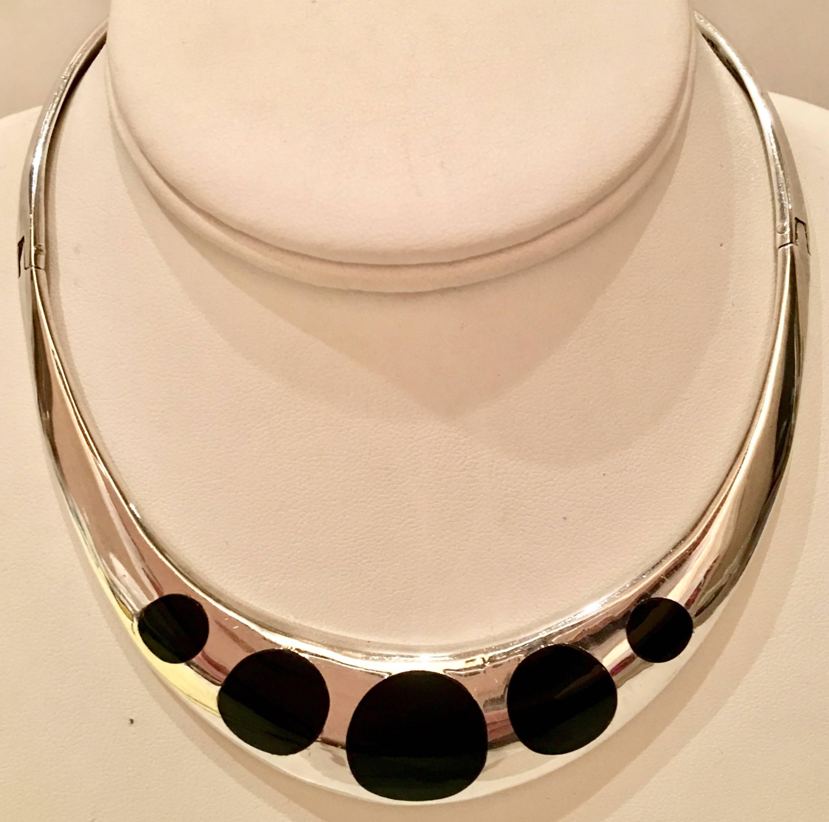 This exceptional and fine modernist signed sterling Taxco hinge collar necklace features five round polished black onyx inlay stones. Stone size varies from .25"; -.75" inches diameter. The design of this double hinged collar intends to