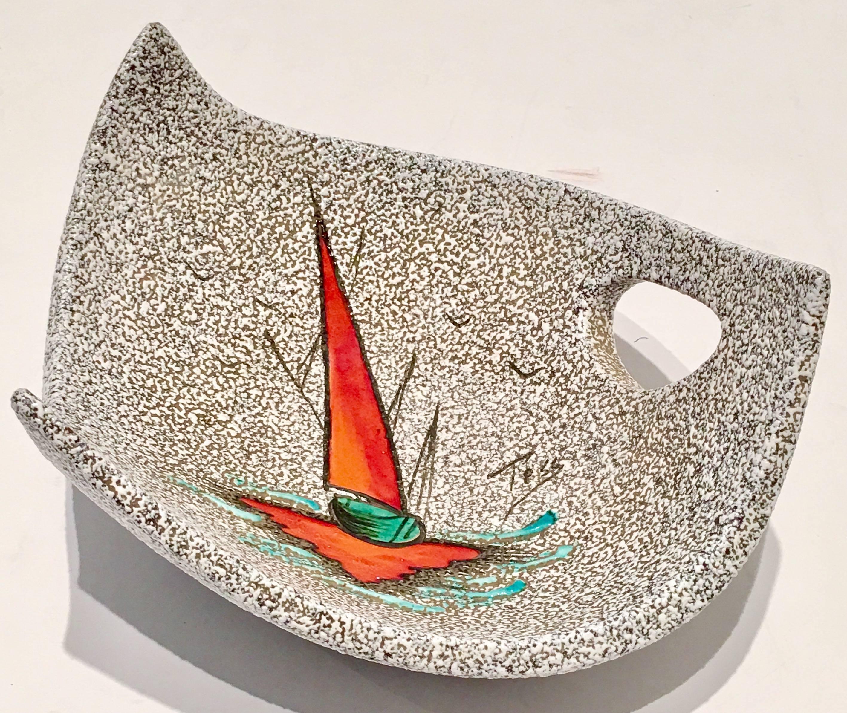 Rare quintessential Mid-Century Modern pair of abstract fish and sailboat Vallarius pottery dish and pitcher signed, Tesy. Incredible "lava" texture black and white abstract forms with cut-out handles. The abstract fish three point dish