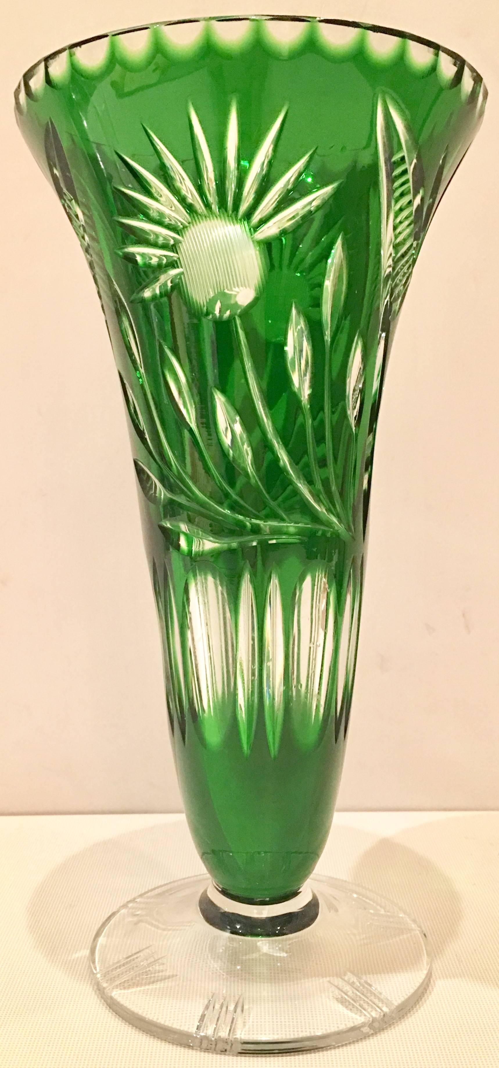 Vintage cut to clear emerald bohemia footed vase. Features a floral cut-out pattern and etched detail on clear foot.