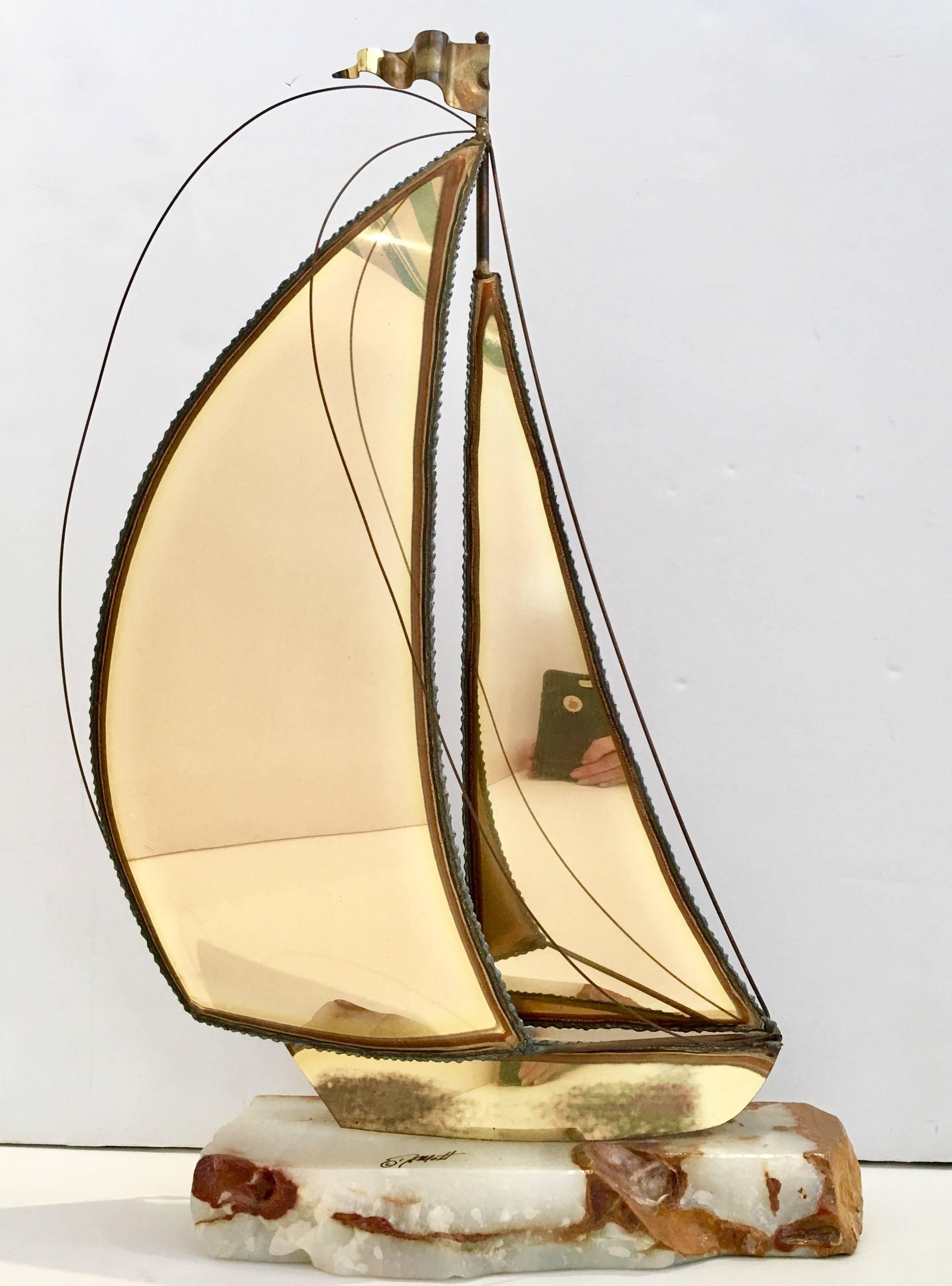 Brass Brutalist sailboat sculpture on raw edge onyx base. Signed, DeMott.