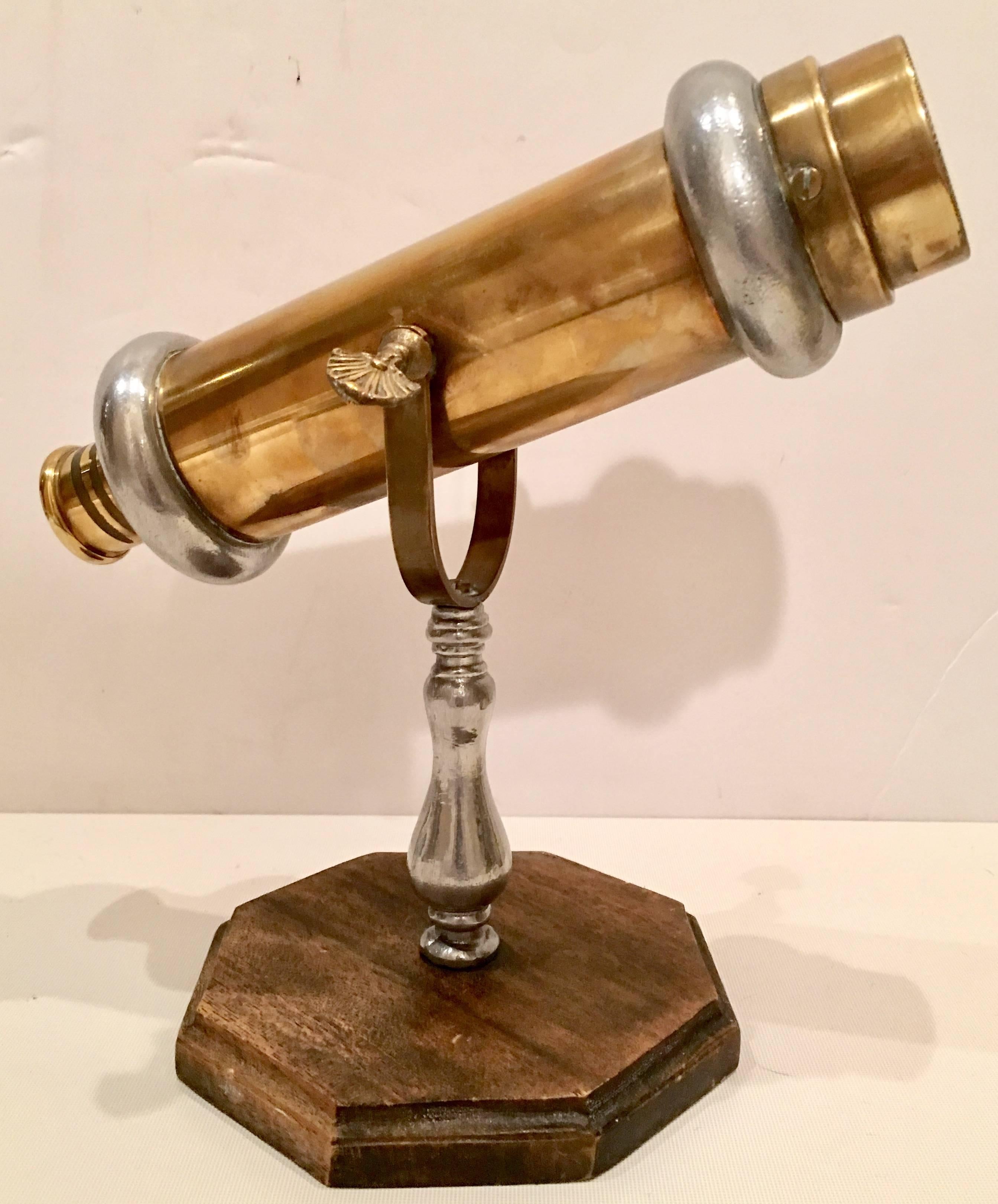Vintage solid brass articulating Kaleidoscope made in Italy. Features an articulating arm solid brass construction with chrome detail. Sits on a wood cut base.