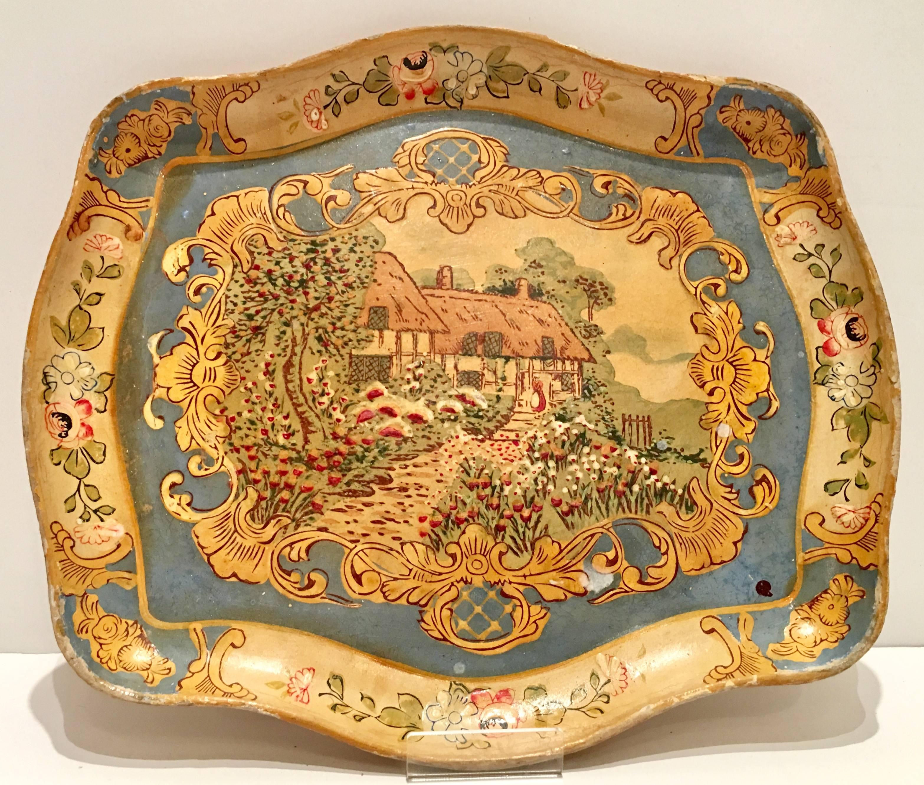 Vintage unique set of three Italian Florentine style papier mâché trays. This collection of three includes one yellow, one red and one blue tray all hand-painted with a gold gilt edge detail and a house in the country motif. Each tray is signed on