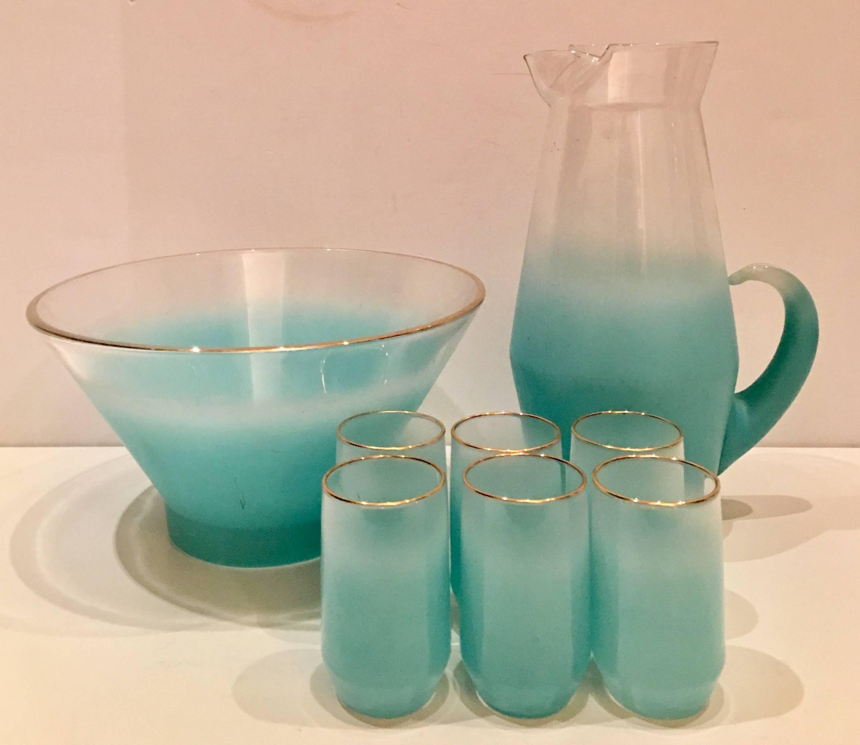 1960s Blendo glass frosted turquoise and 22-karat gold trim detail drinks set of eight pieces. This set features, one large bowl, one handled pitcher and six drink glasses. Each glass measures: 4" H x 2.13" diameter. Large bowl measures,