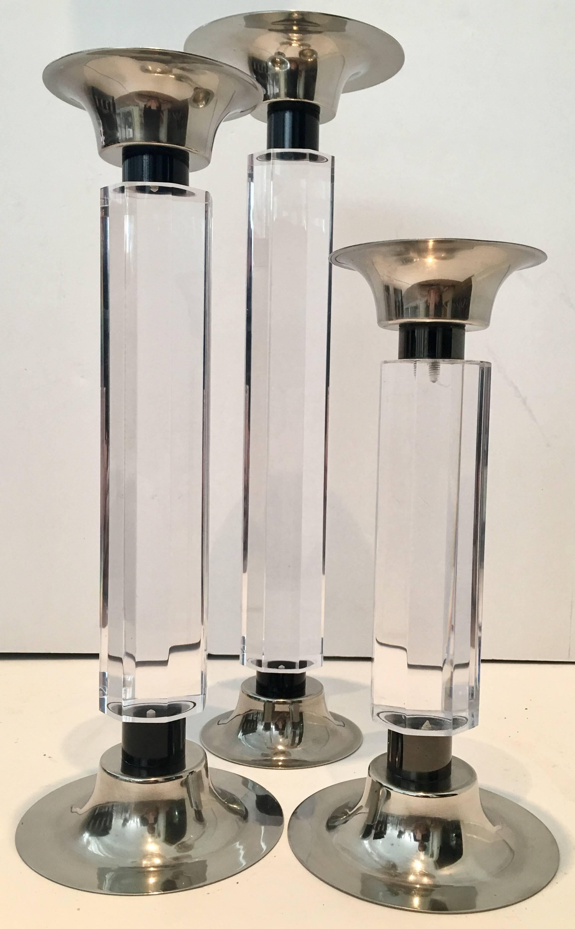 1970'S Set Of Three Faceted Lucite & Poliched Chrom Column Candle Holders, In the manner of Charles Hollis Jones. This substantial trio of faceted Lucite and chrome pillar candle holders.. Vary in height. Each piece has eight faceted sides. Features