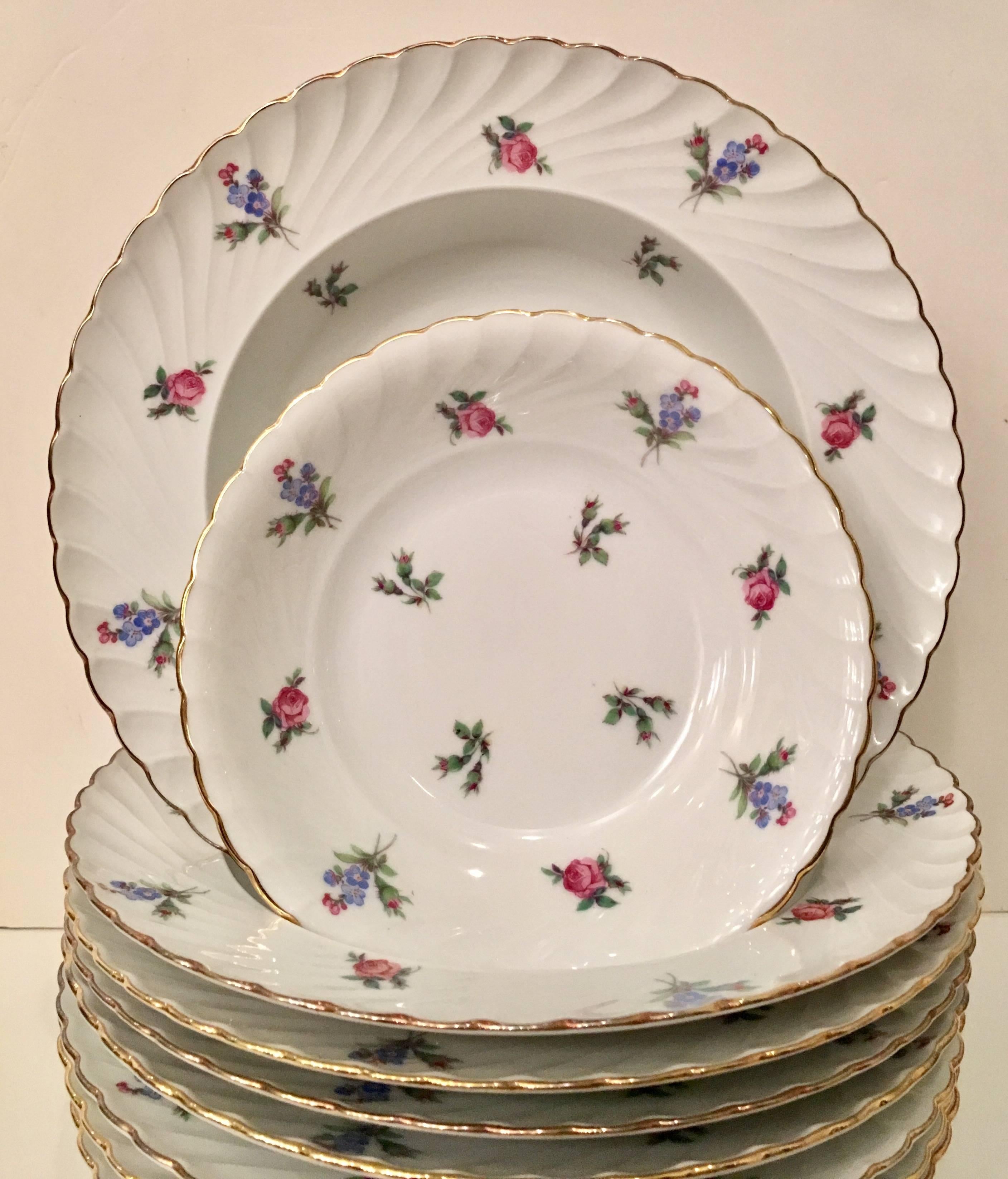 Vintage German Porcelain with 22-carat gold trim,"Dresden Flowers" by Royal Tettau. Pattern features a bright white ground with floral in pink, purple, green and red, 22-carat gold rim and scalloped edge. Each piece is hallmarked on the