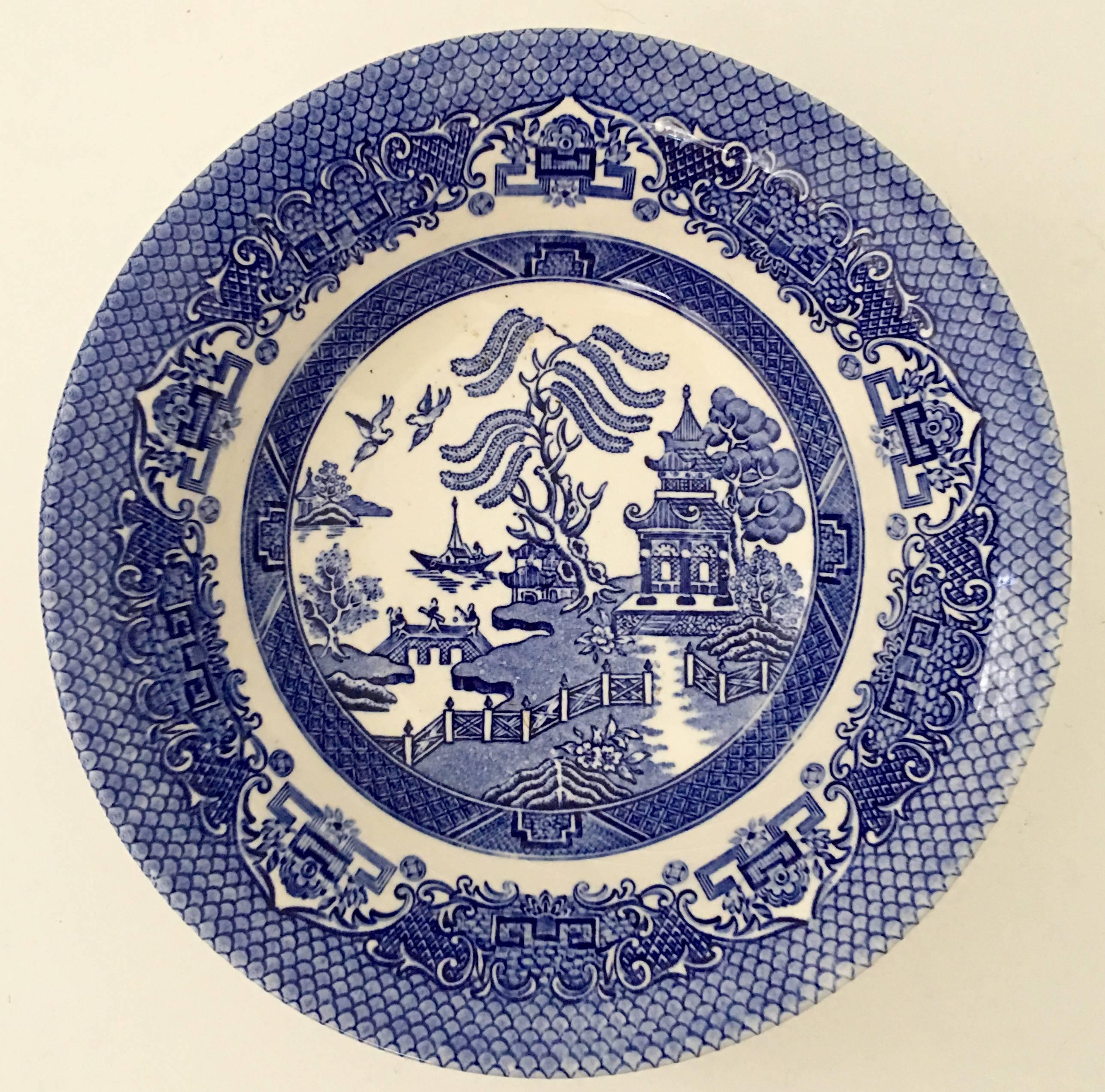 English ironstone of ten pieces in the "Blue Willow" pattern. This ten piece set features, four dinner plates, four coupe soup or cereal bowls, one large serving bowl and one oval platter. Each piece except the platter is marked on the