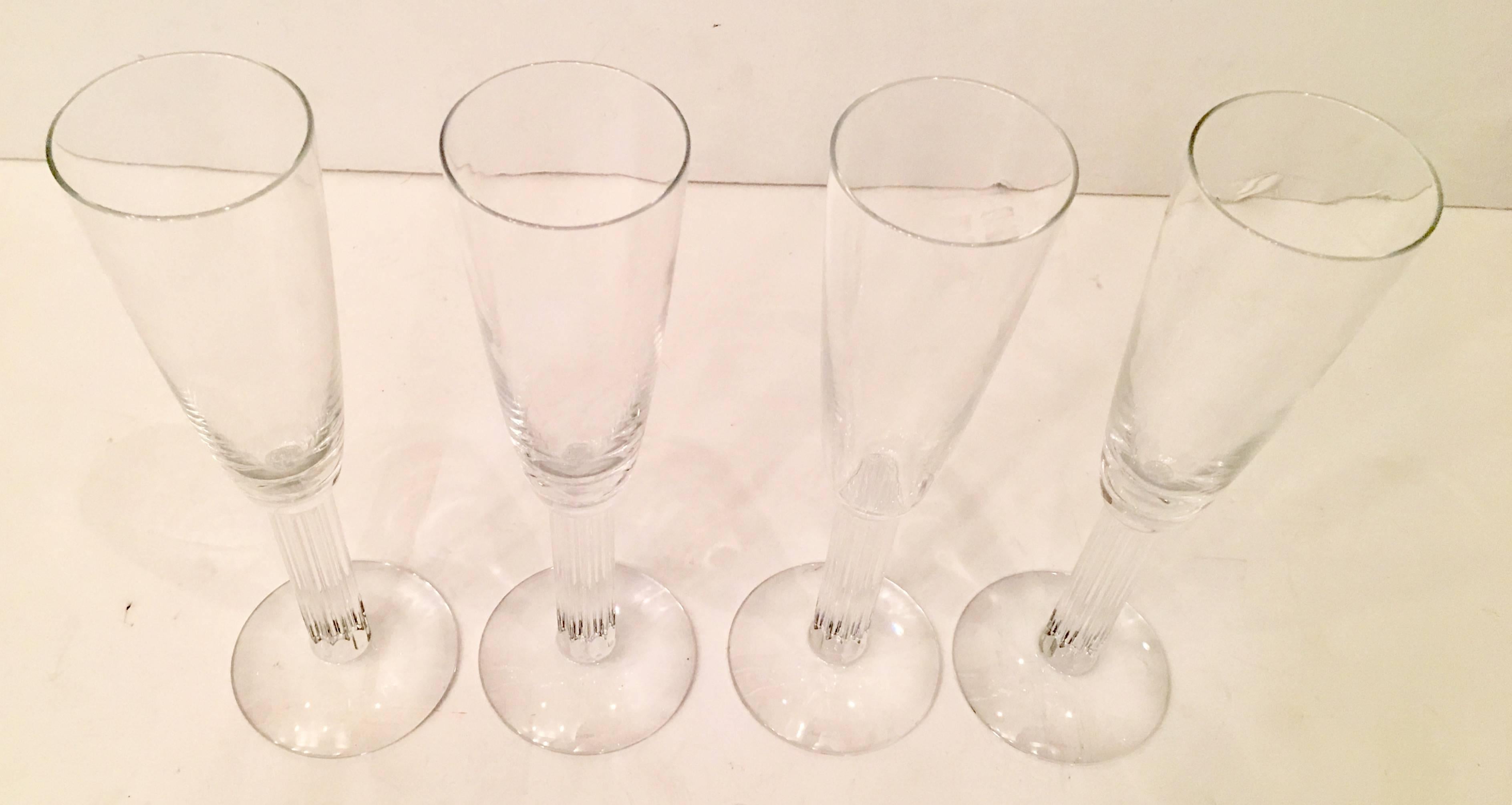 1980s set of four Baccarat France crystal stem champagne flutes in the pattern, Lyra. Each of these column motif glasses is signed Baccarat on the front of the foot and Baccarat France on the centre underside. This pattern is no longer in production.